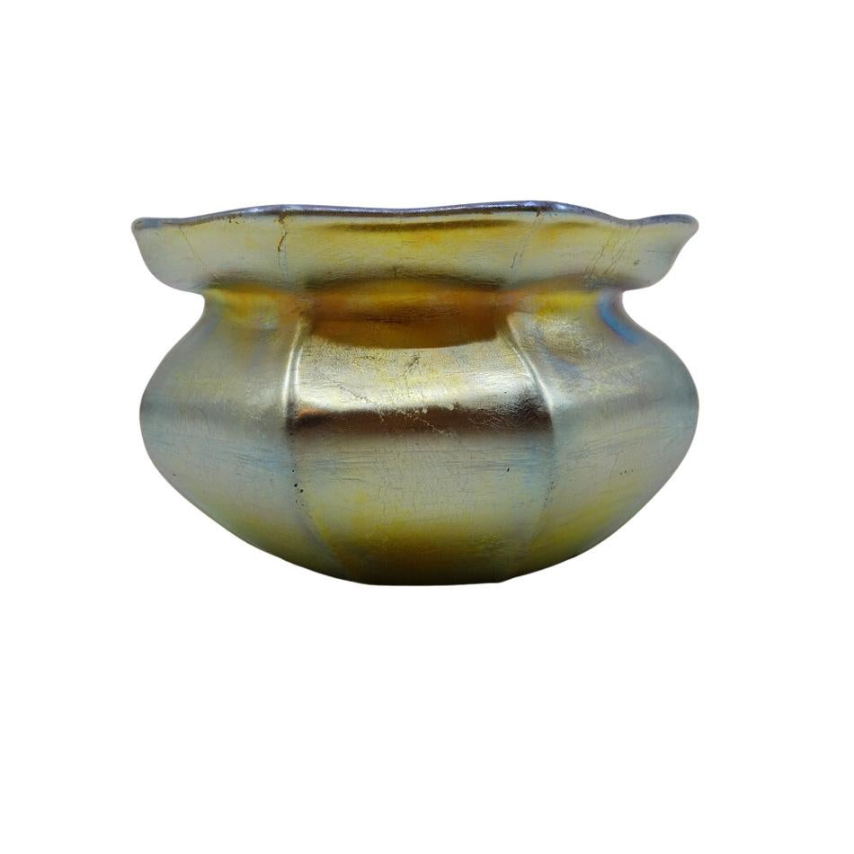 Offering this diminutive Louis Comfort Tiffany gold Favrile iridescent art glass cabinet vase. This cabinet vase features a six-ribbed cinched body with a flared mouth in rare dark amber (almost black) glass. Signed on the underneath 