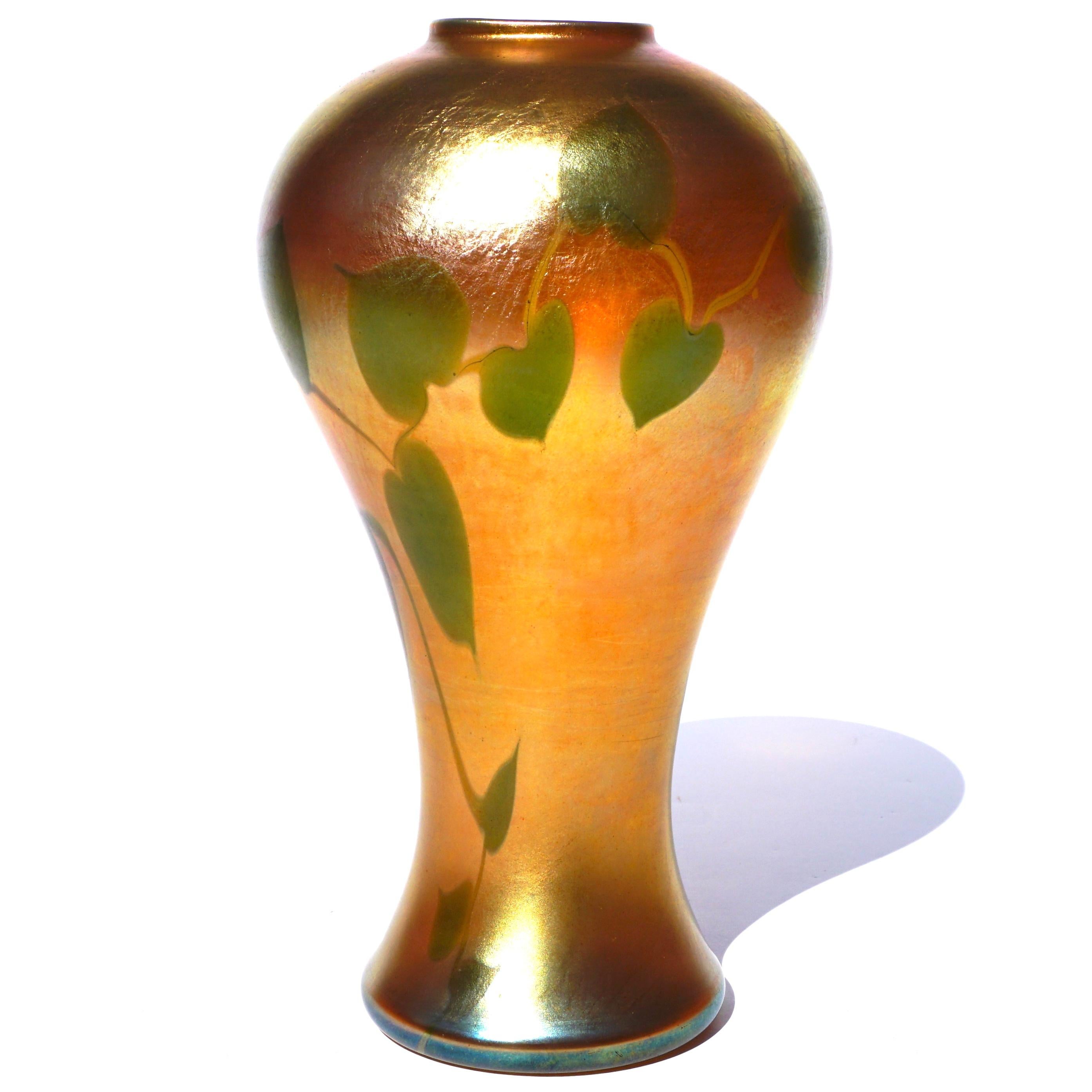 Tiffany Studios Favrile glass leaf and vine vase, circa 1910. With a desirable bulbous rimmed form and a beautiful deep gold irredentist favrile effect decorated with leaves and vines. A very nice addition to your Art Nouveau - Art Deco decor or Art