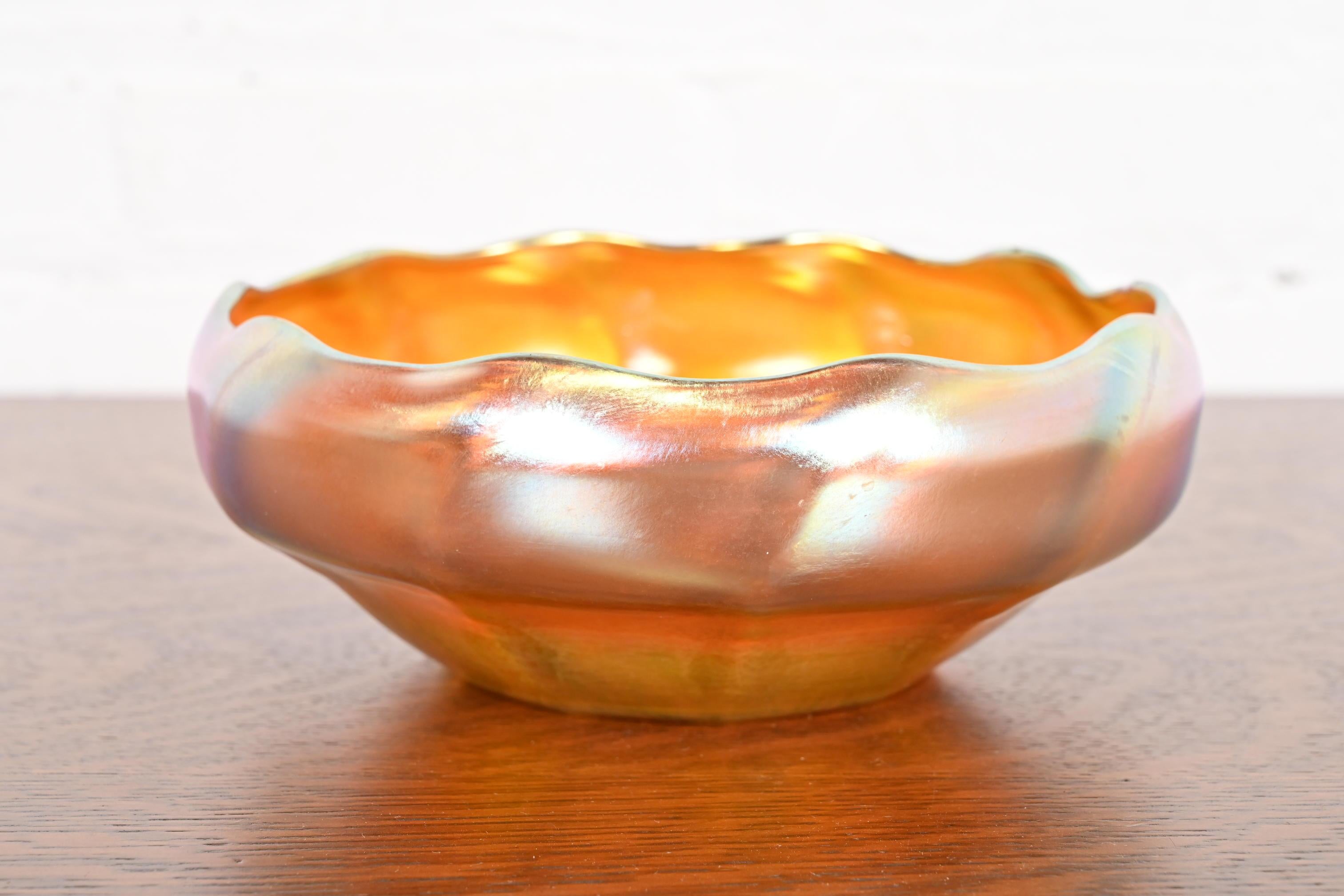A gorgeous Arts & Crafts or Art Nouveau period Favrile iridescent art glass bowl with scalloped edge

By Louis Comfort Tiffany for Tiffany Studios (signed to the underside)

USA, Circa 1910

Measures: 8.75