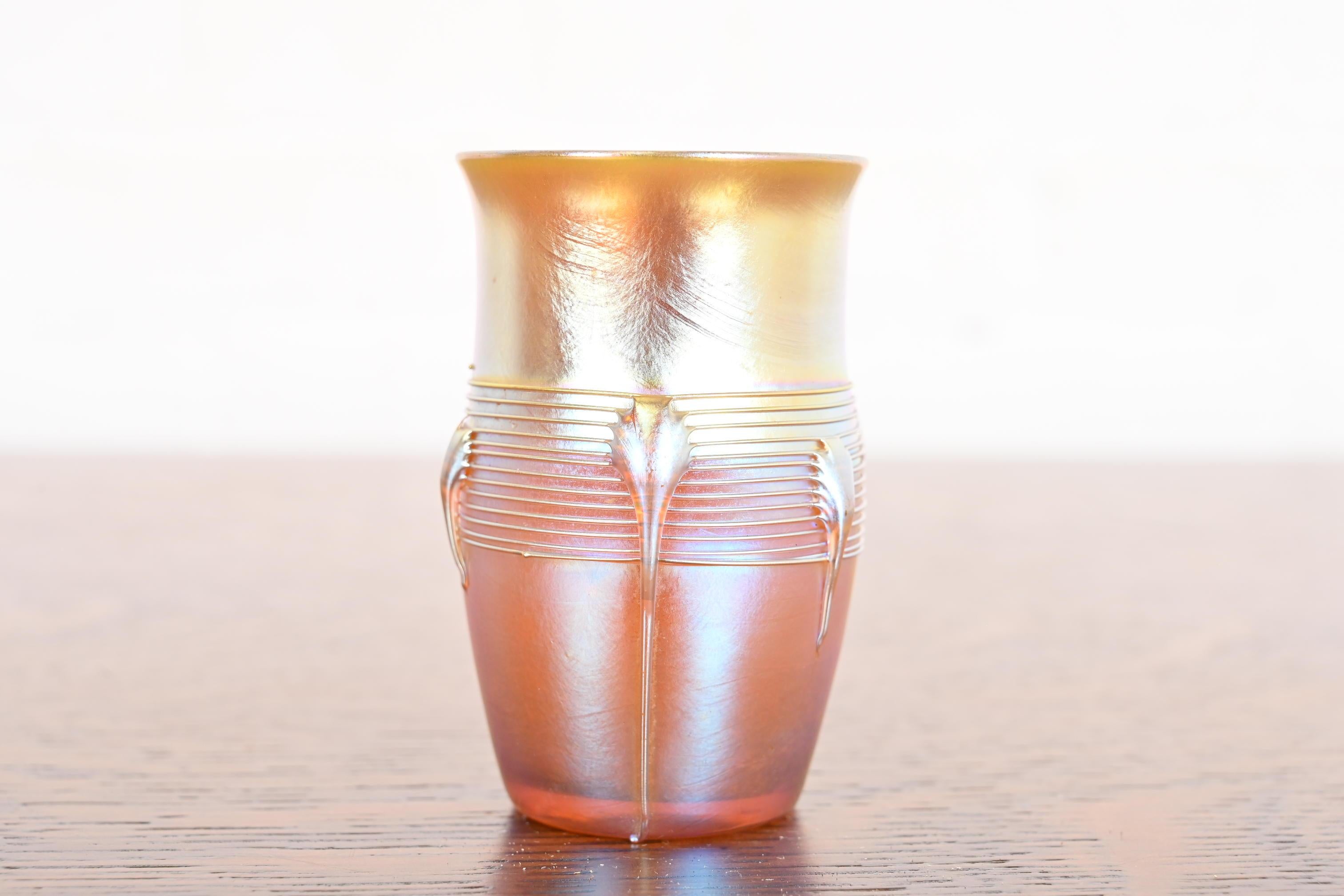 A gorgeous Arts & Crafts or Art Nouveau period Favrile iridescent art glass cabinet vase

By Louis Comfort Tiffany for Tiffany Studios (signed to the underside)

USA, Circa 1910

Measures: 2.38