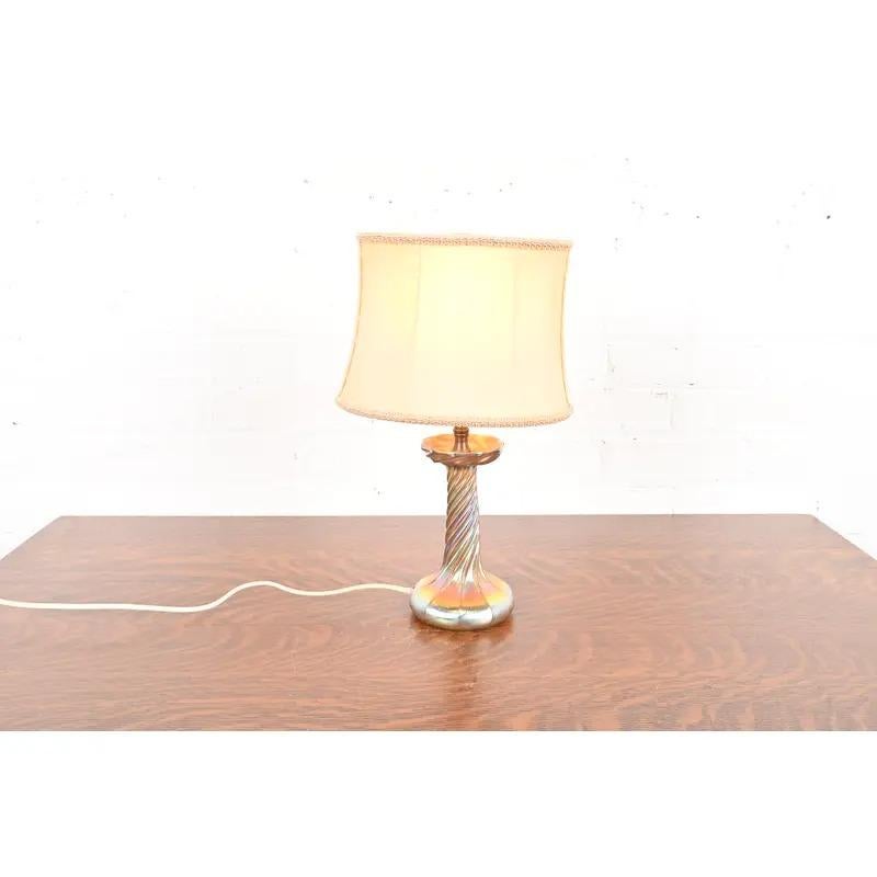 A gorgeous Arts & Crafts or Art Nouveau period Favrile iridescent art glass candlestick table lamp

By Louis Comfort Tiffany for Tiffany Studios (base signed 