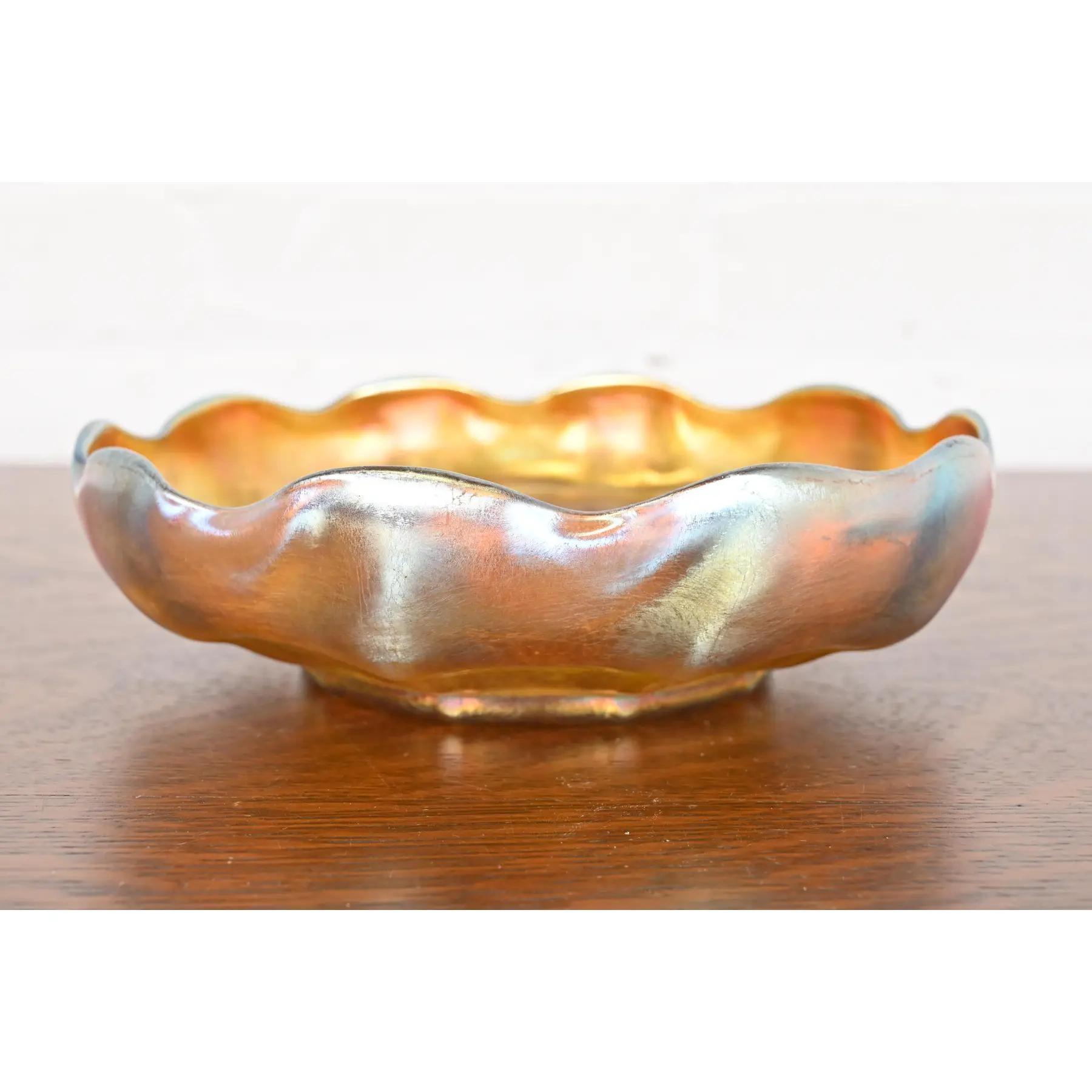 A gorgeous Arts & Crafts or Art Nouveau period Favrile iridescent art glass large scalloped center bowl or fruit bowl

By Louis Comfort Tiffany for Tiffany Studios (signed to the underside)

USA, Circa 1910

Measures: 8.75