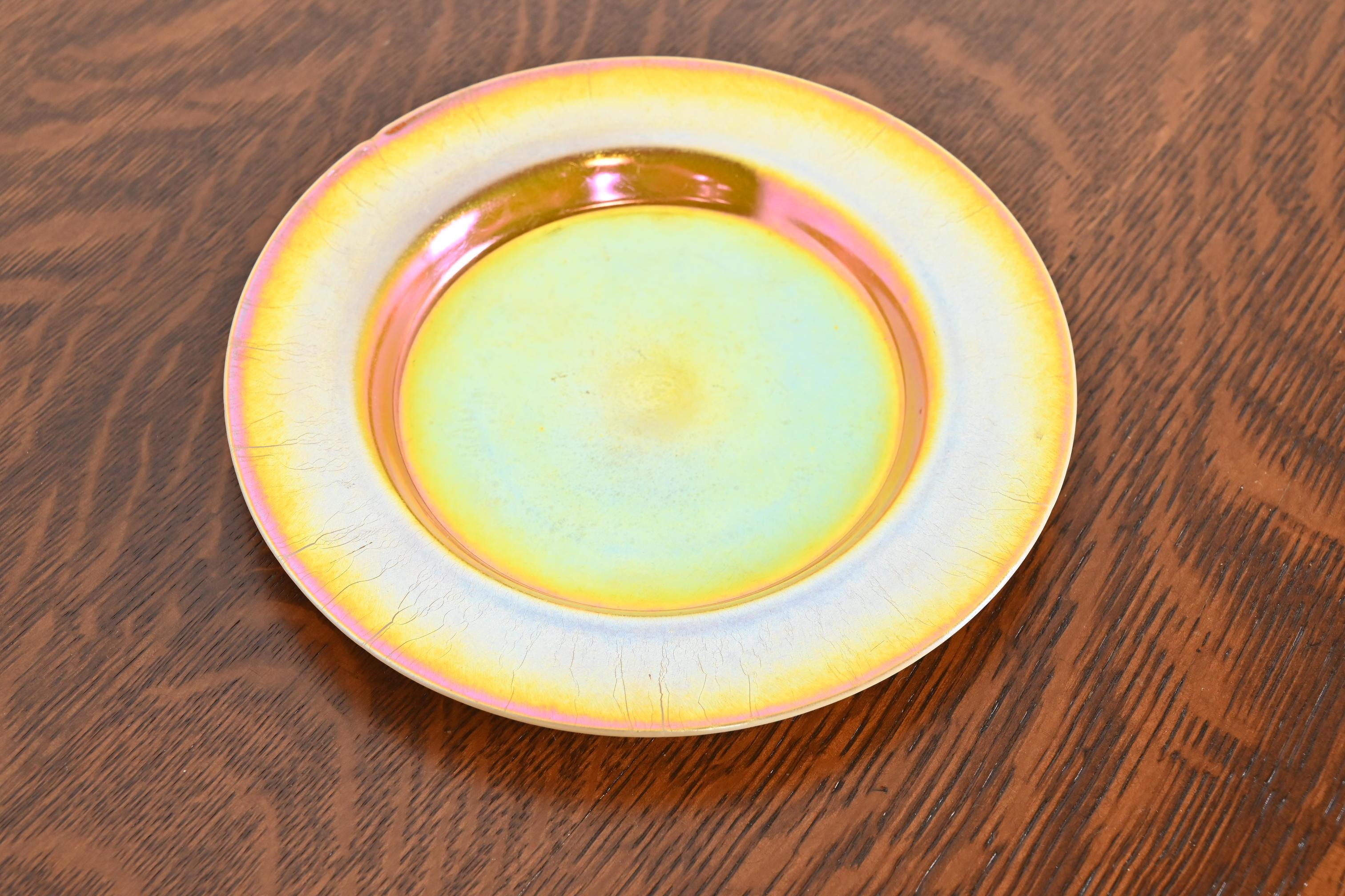 A gorgeous Arts & Crafts or Art Nouveau Gold Aurene art Ceramic plate.

By Louis Comfort Tiffany for Tiffany Studios

USA, Circa 1900

Measures: 8