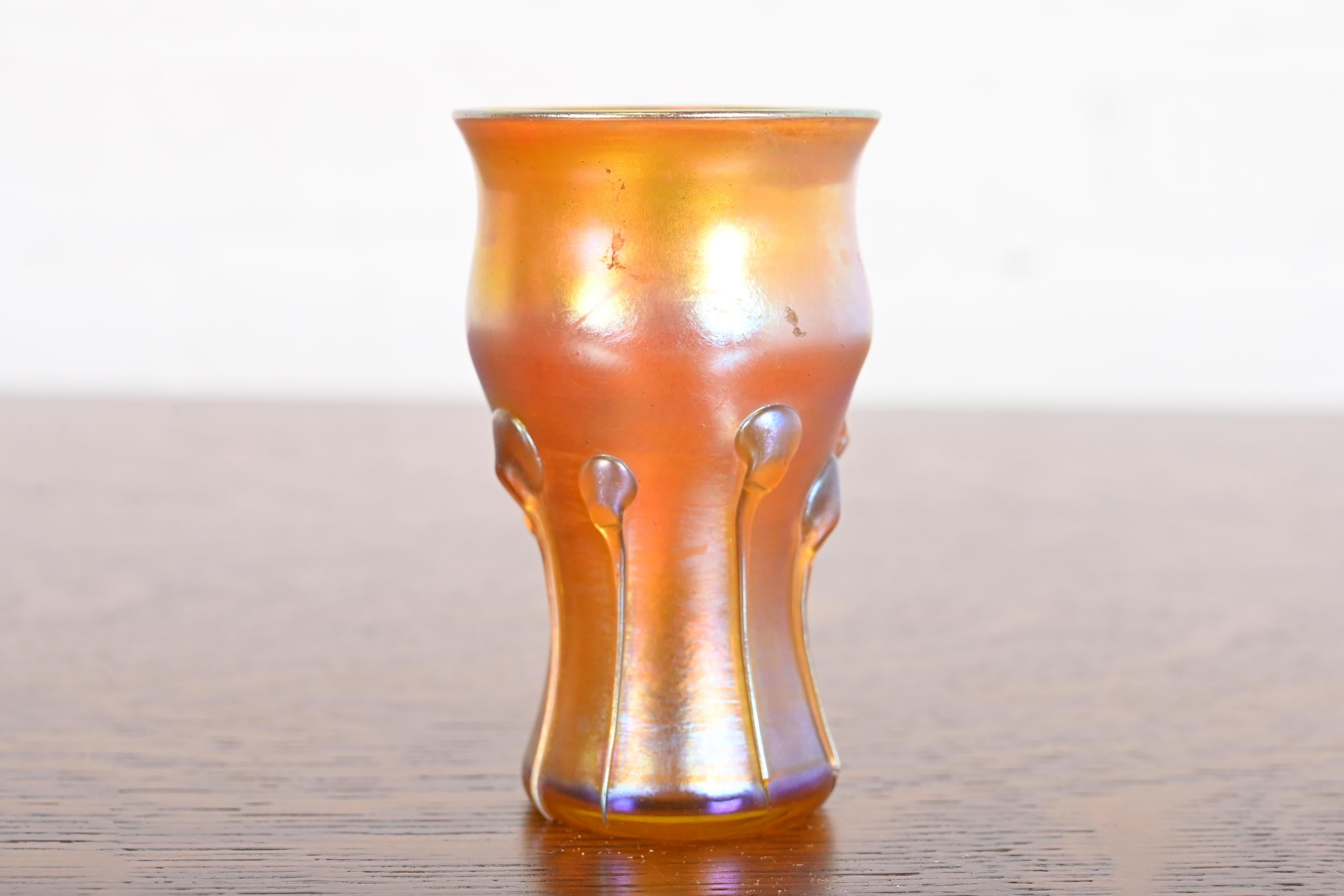A gorgeous Arts & Crafts or Art Nouveau period Favrile iridescent art glass vase with tadpole design

By Louis Comfort Tiffany for Tiffany Studios (signed to the underside)

USA, Circa 1910

Measures: 2.5
