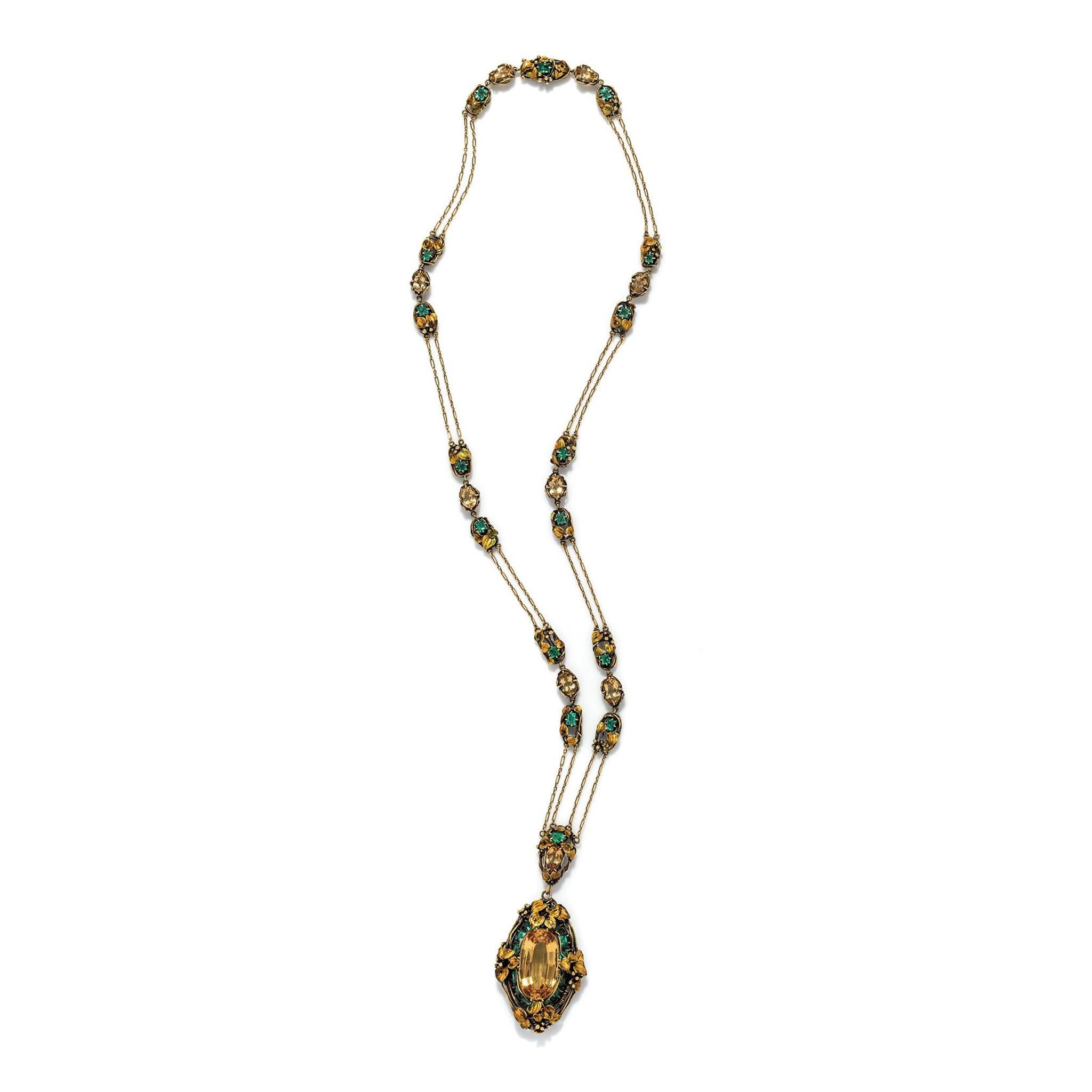 Dating from 1910-1915, this unusual and alluring necklace belongs to a group of jewels exploring one of Louis Comfort Tiffany’s favorite motifs, the fruiting grapevine, in a blue-green and gold palette. The pendant, with its substantial golden topaz