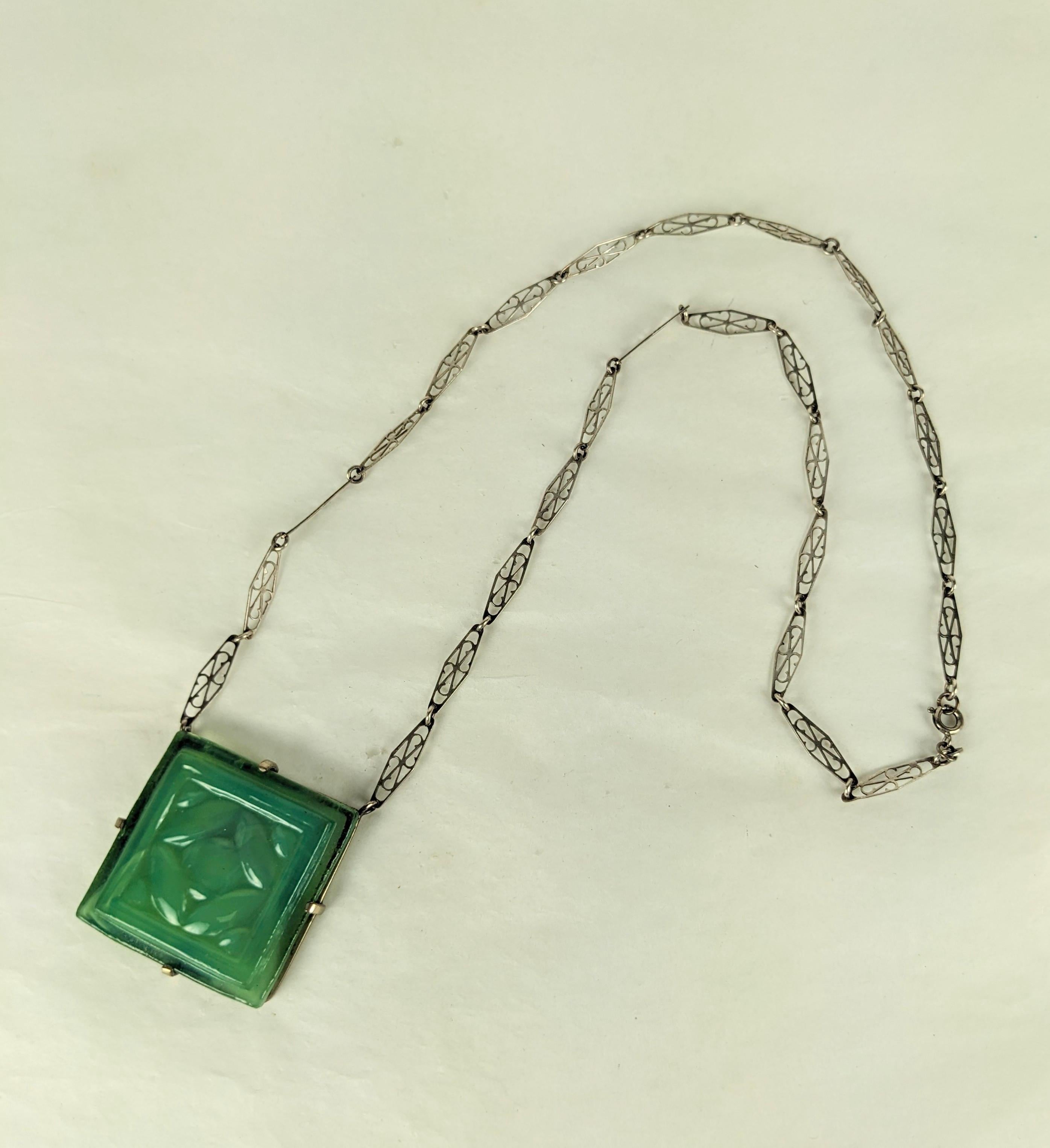 Louis Comfort Tiffany Glass Tile Arts and Crafts Pendant from the turn of the 20th Century. Pale emerald green molded glass tile with slightly opalescent milky center set in a pronged setting.
Fine Hand carved sterling openwork Arts and Crafts