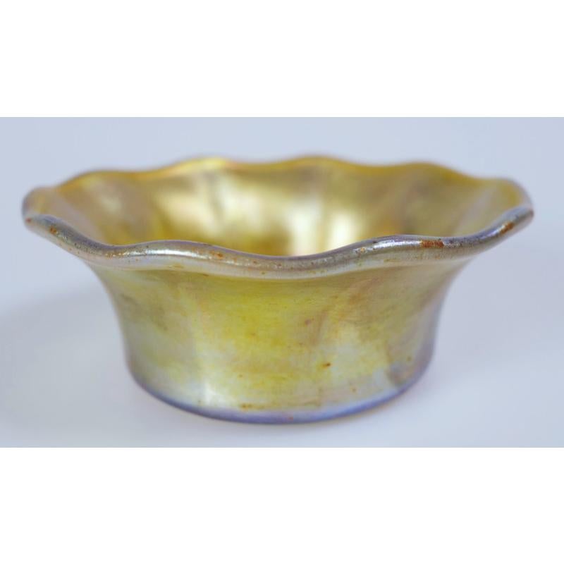 Offering this diminutive Louis Comfort Tiffany gold Favrile iridescent art glass dish. This 