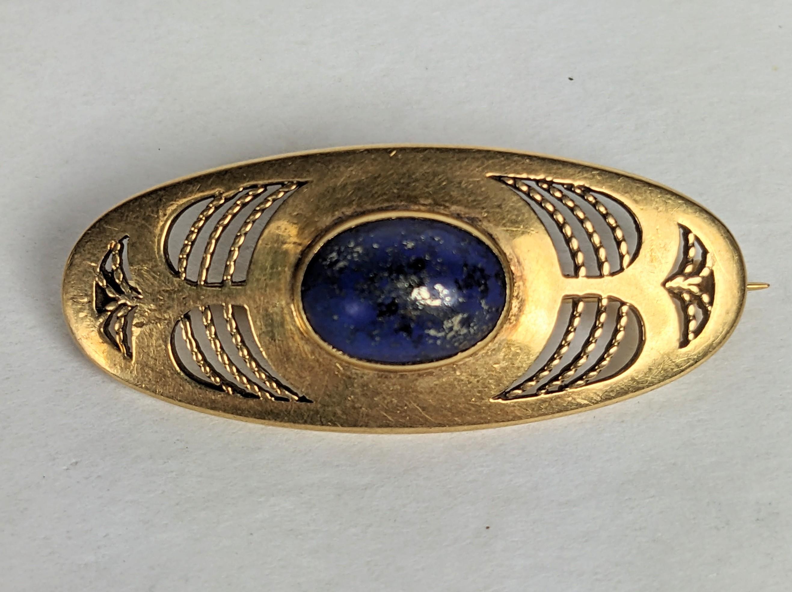 Lovely Louis Comfort Tiffany Lapis Arts and Crafts Brooch from the early 1910's. Spare design of openwork cut outs with twisted wire work inserts likely designed  in the early 1910's for Tiffanys Art Jewelry Dept. The central lapis lazuli has gold