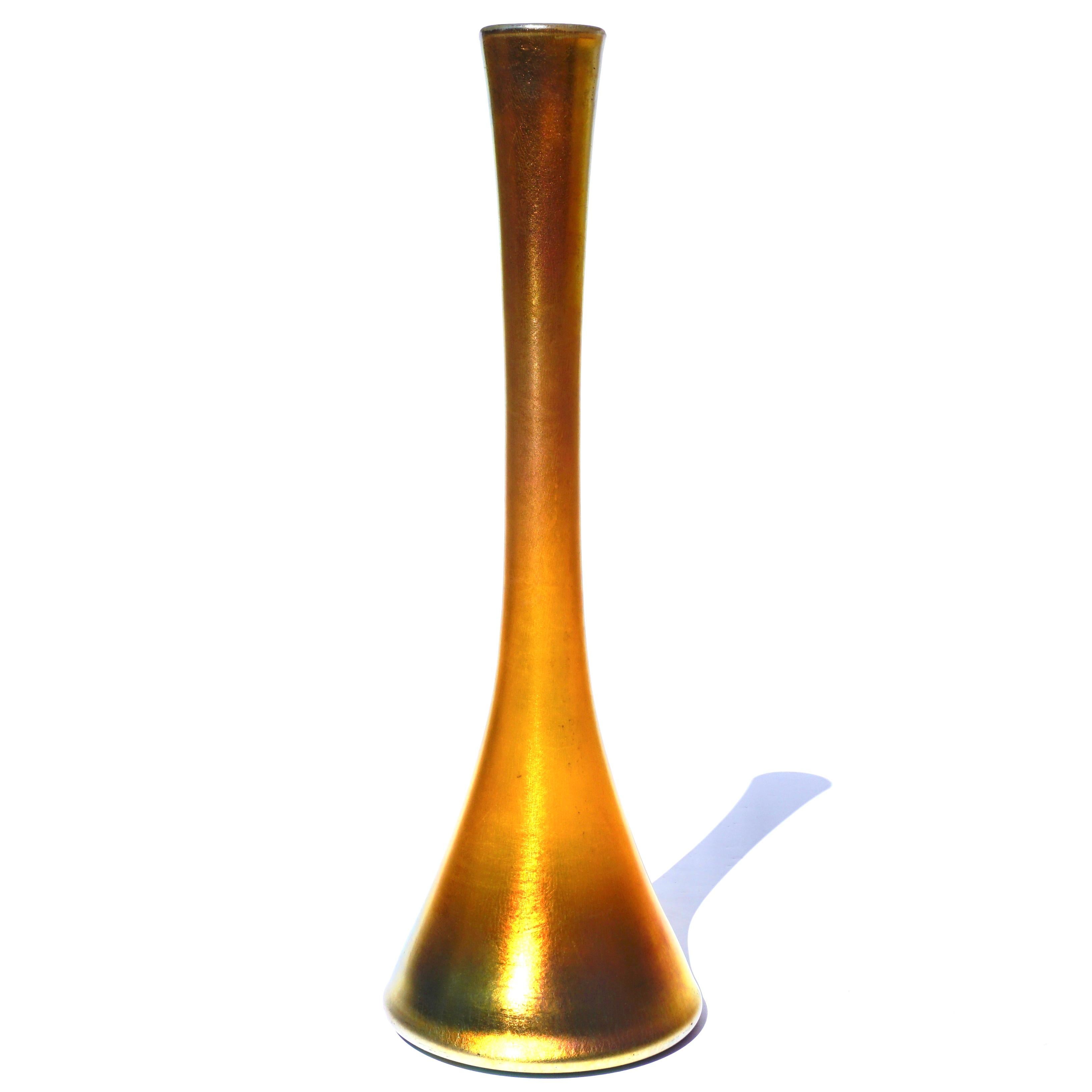 A large 16.5 inch gold favrile Bottle vase, circa 1900 Art Nouveau.

Marks: 6505, K, L.C. Tiffany, Favrile
Measures: Height 16.5 inches (41.9 cm) 
Diameter 5.5 inches (13.7 cm)

Condition: Very good with minor losses to iridescence.

AVANTIQUES is