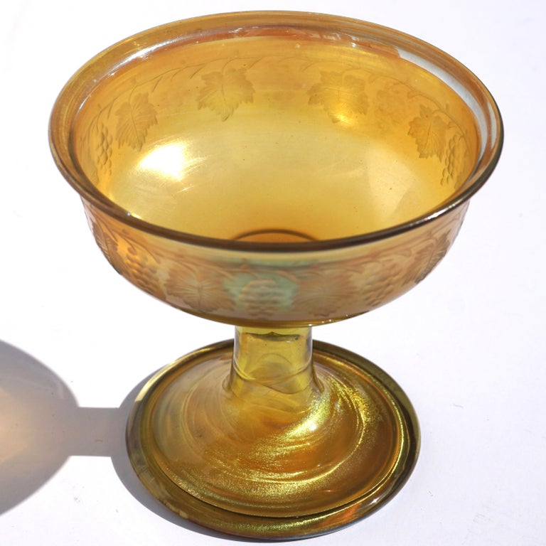 A wonderful L.C.T. gold Favrile champagne or sorbet glass cup with engraved grape clusters and wine leaves.

Engraved signature: “L.C.T. Favrile”

Measures: Height 3.4 Inches, diameter 3.6 inches

Condition: Excellent 

AVANTIQUES is dedicated to