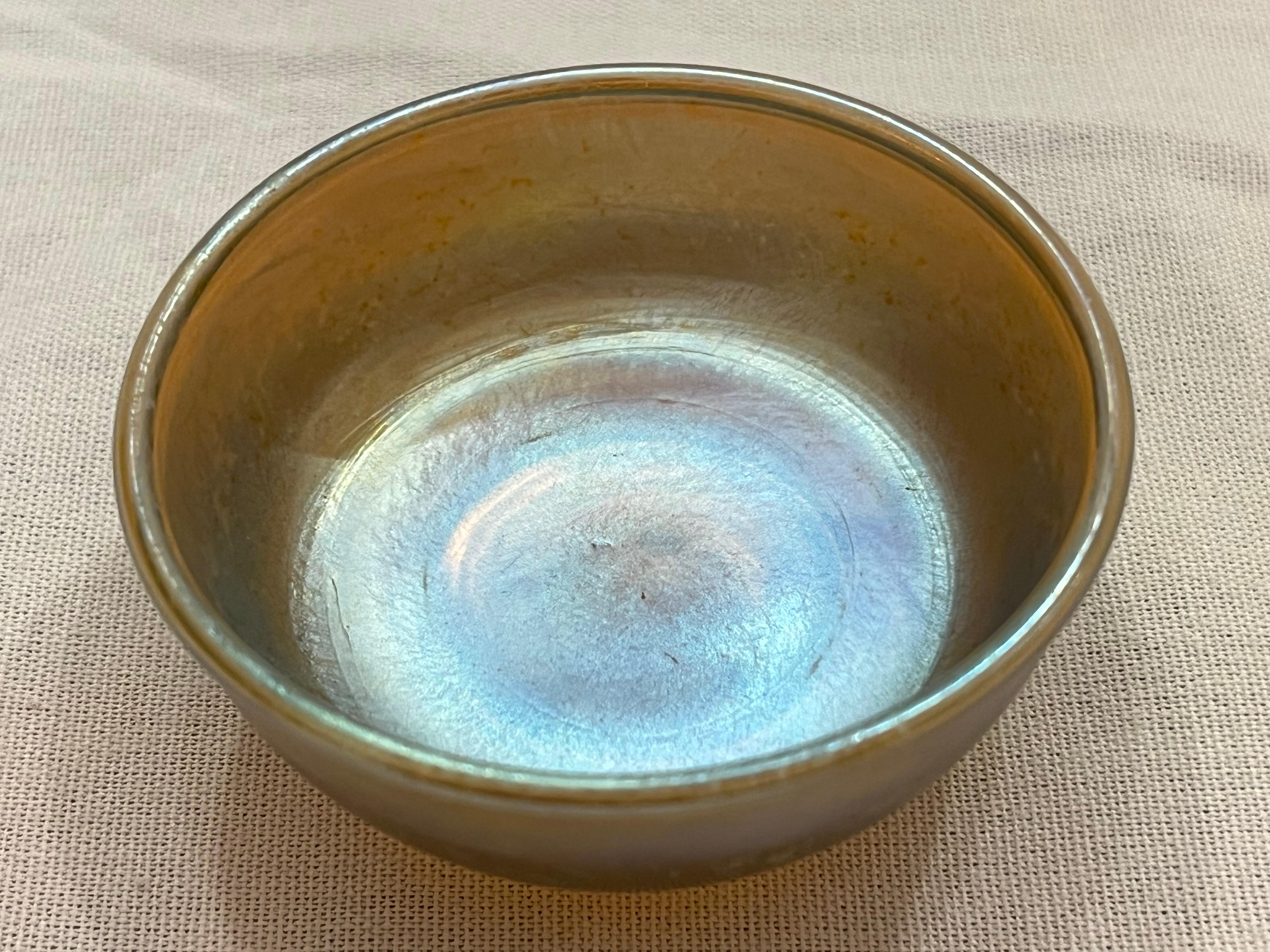 A beautiful favrile glass bowl by Louis Comfort Tiffany. This piece is signed with initials, L.C.T. and marked with the word Favrille. From Wikipedia, 