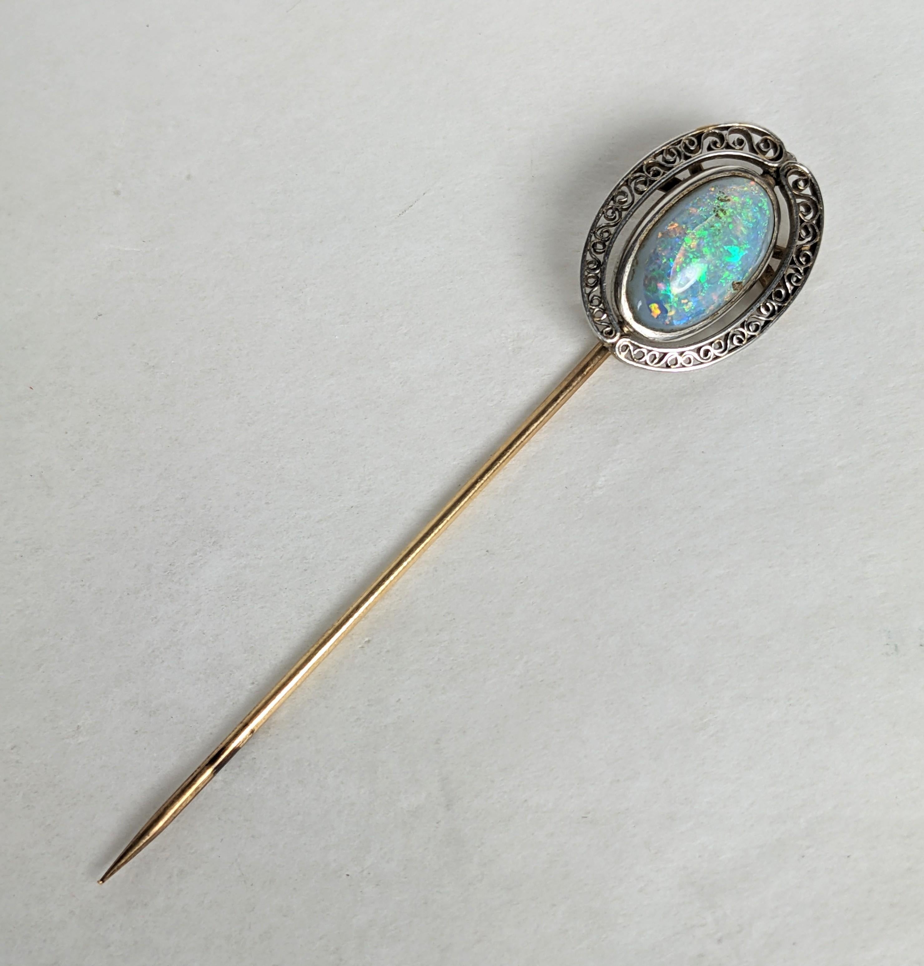 Louis Comfort Tiffany Opal and Filigree Stick Pin. Cabochon opal bezel set within a filigree frame of platinum openwork, set on a yellow gold 18k shaft. The stones chosen for the artisanal line of LCT for Tiffanys weren't always technically perfect,