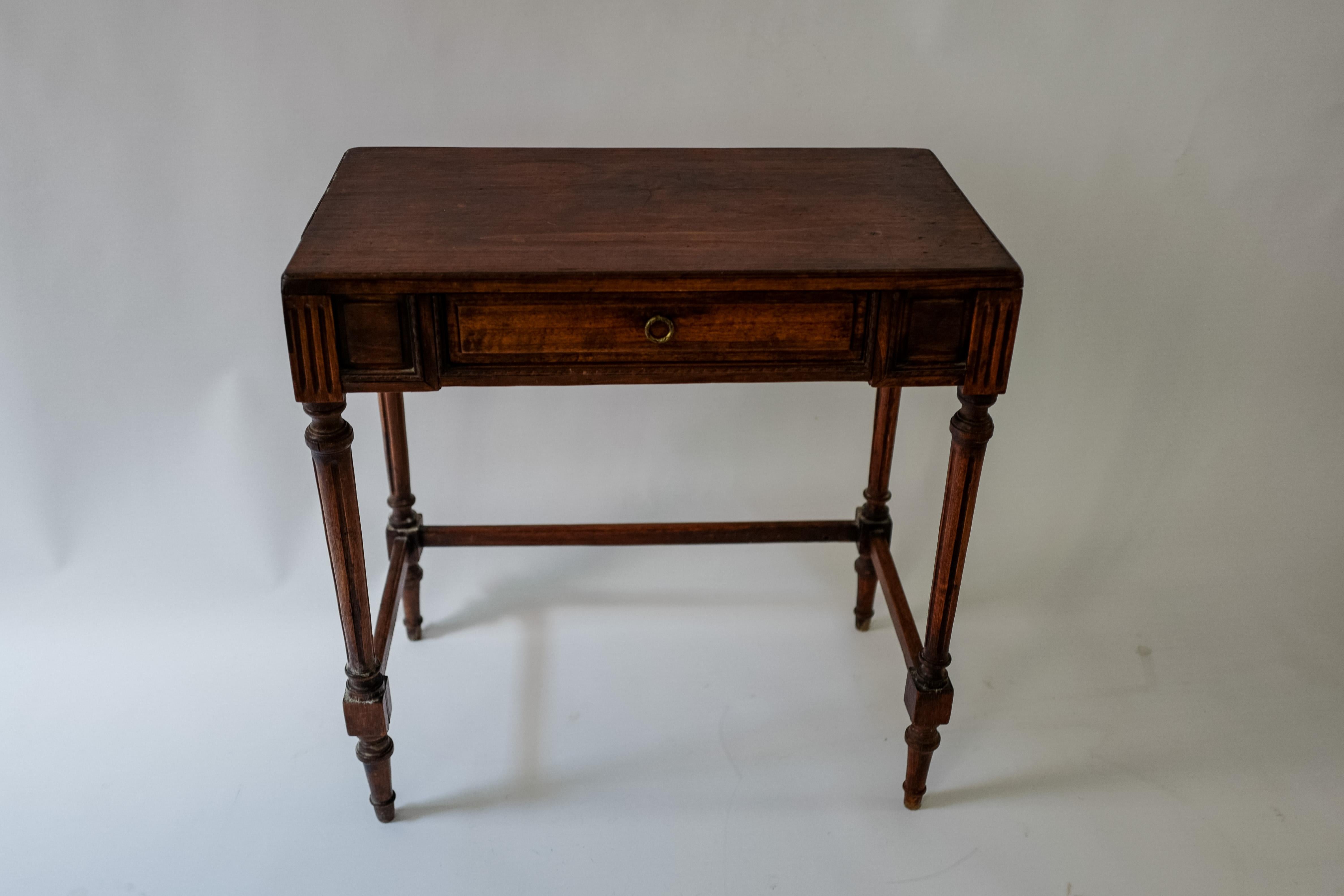 A petit late 19th Century French Louis console made of stained oak. Beautifully hand carved details and a single drawer with pull. Lightweight. 