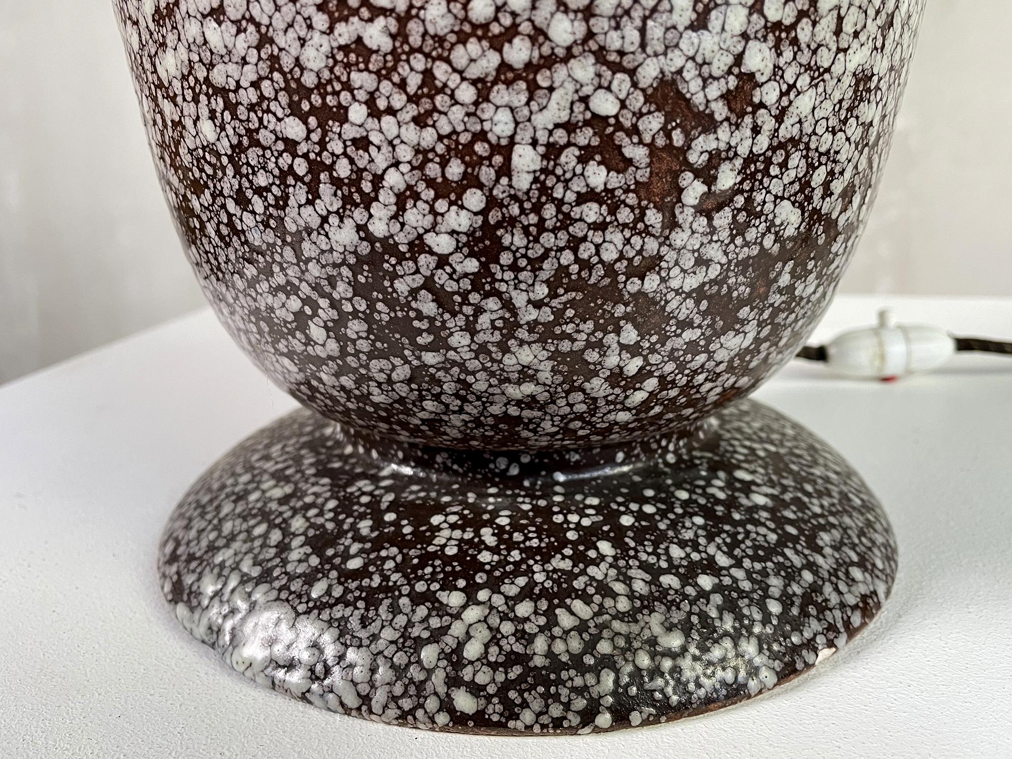 Beautiful ceramic bowl lamp by Louis Dage, France, circa 1930. On a green and brown background, the ceramicist has projected droplets of white enamel, creating a material and gradient effect. The interior of the bowl is enameled in white, with