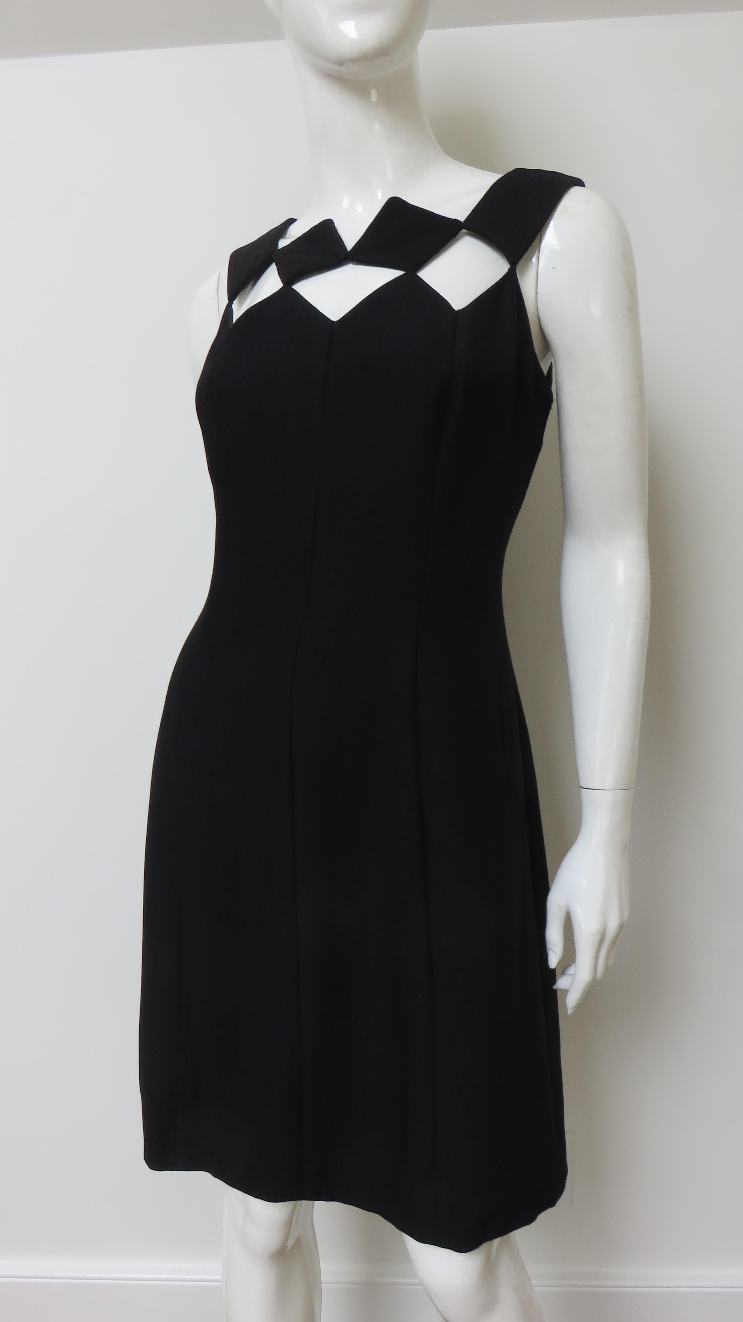 A fabulous little black dress from Louis Estevez.  It is sleeveless with the front and back neckline comprised of fabric squares leaving squares of exposed skin. The dress is a subtle A line fully lined with a back hand sewn zipper.
Fits sizes