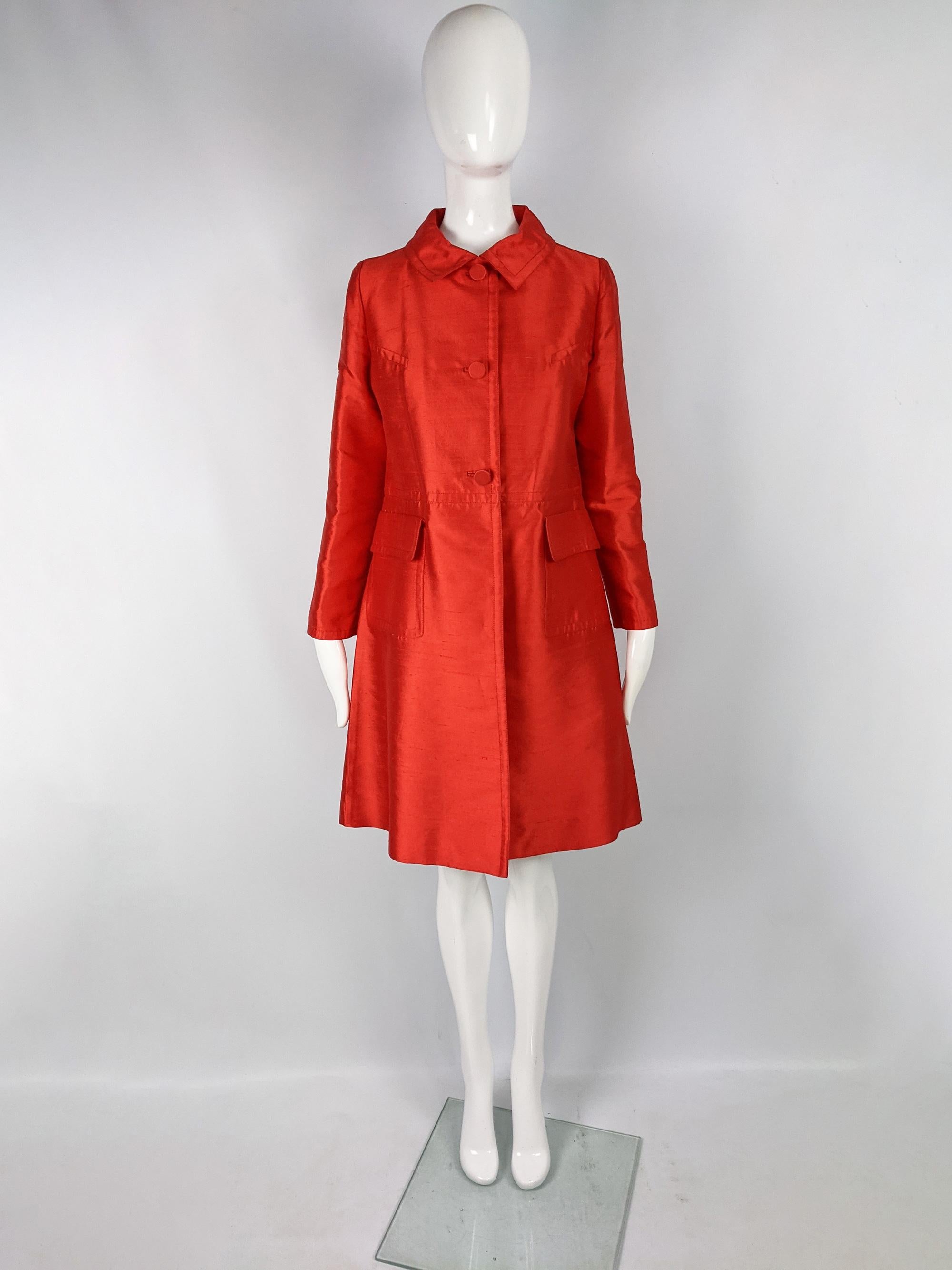 An incredible vintage womens opera coat from the 60s by luxury French fashion designer, Louis Féraud. In a red wool and silk blend fabric with an A-line silhouette. Perfect for a party or evening event or dressing it down for a bold, glamorous touch