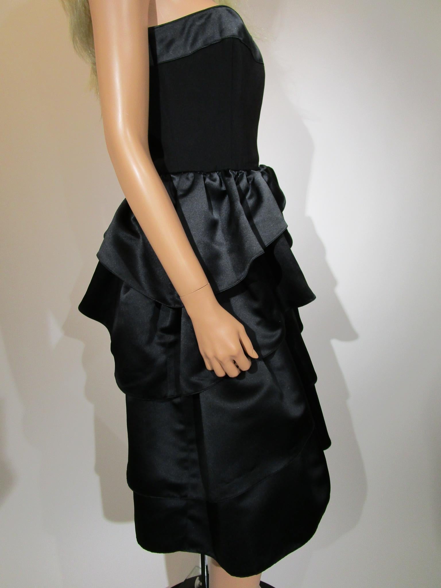 Gorgeous Louis Feraud strapless black dress with elegant, tiered ruffles (5 tiers) ending in a straight skirt.  Bodice lining has a boned construction and zips up the side.

Dress is in excellent condition with no stains, rips or holes.
Marked