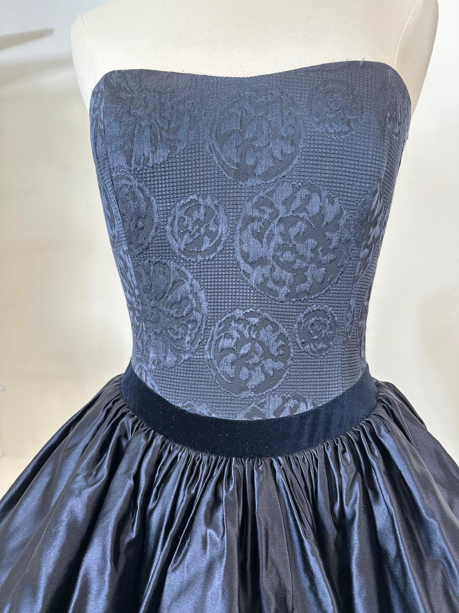  
Louis Feraud blue silk damask strapless bodice with tiered poof skirt, evening gown with train from the 1980s. This gorgeous dress has a fitted boned bodice of blue figured silk damask. The long skirt is dark blue silk with two layers of full
