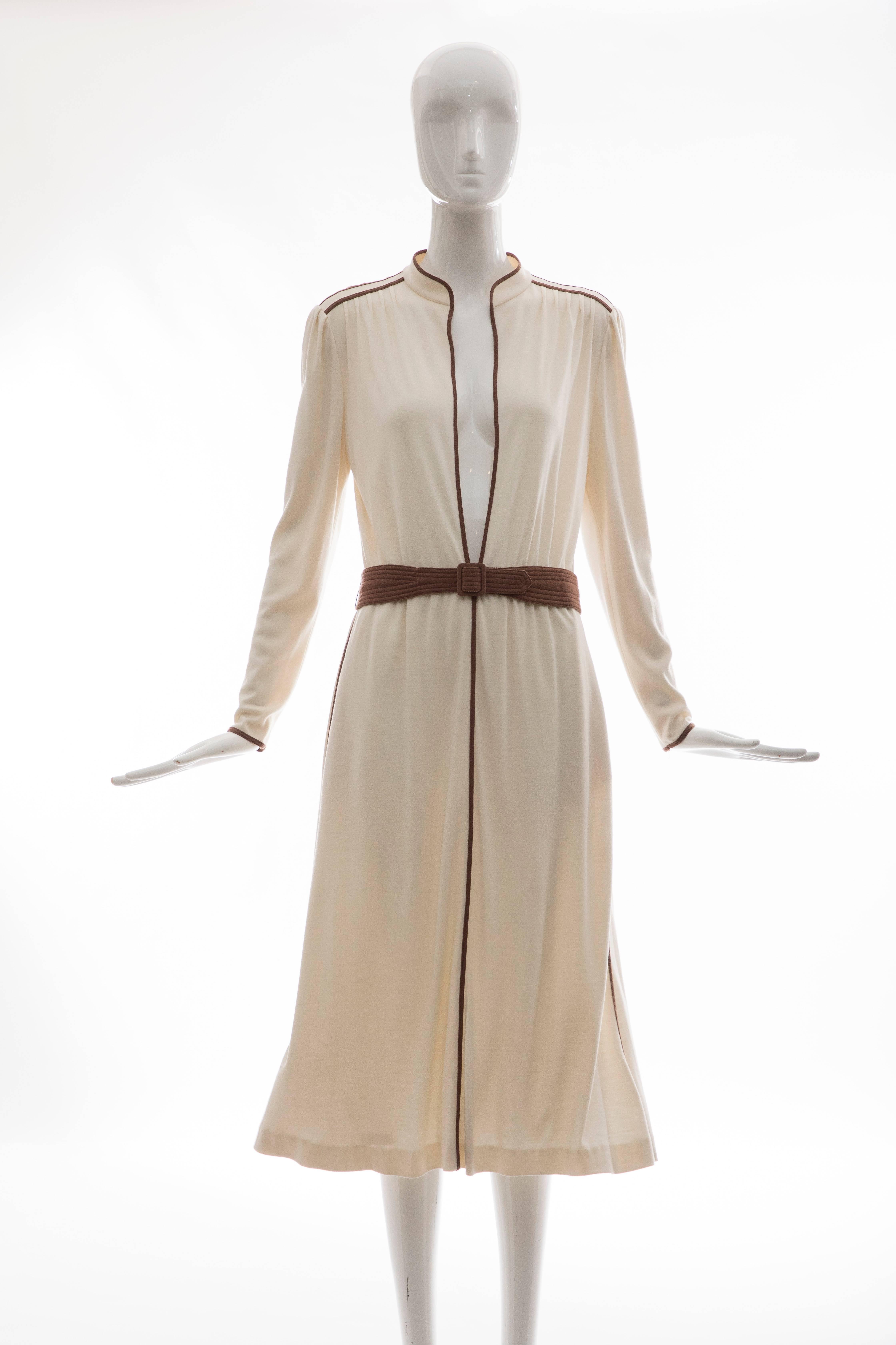 Louis Feraud, Circa 1980's cream cotton jersey dress with deep V neckline, cinnamon trim and quilted belt, two front pockets and lined in silk.

Bust 36, Waist 28, Hips 46, Length46 