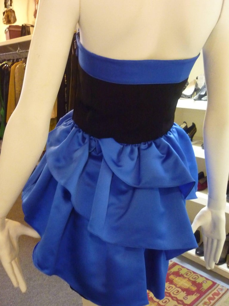 Crepe and satin blue and black dress, with elegant graduated ruffles ending in a straight skirt, and a boned top.