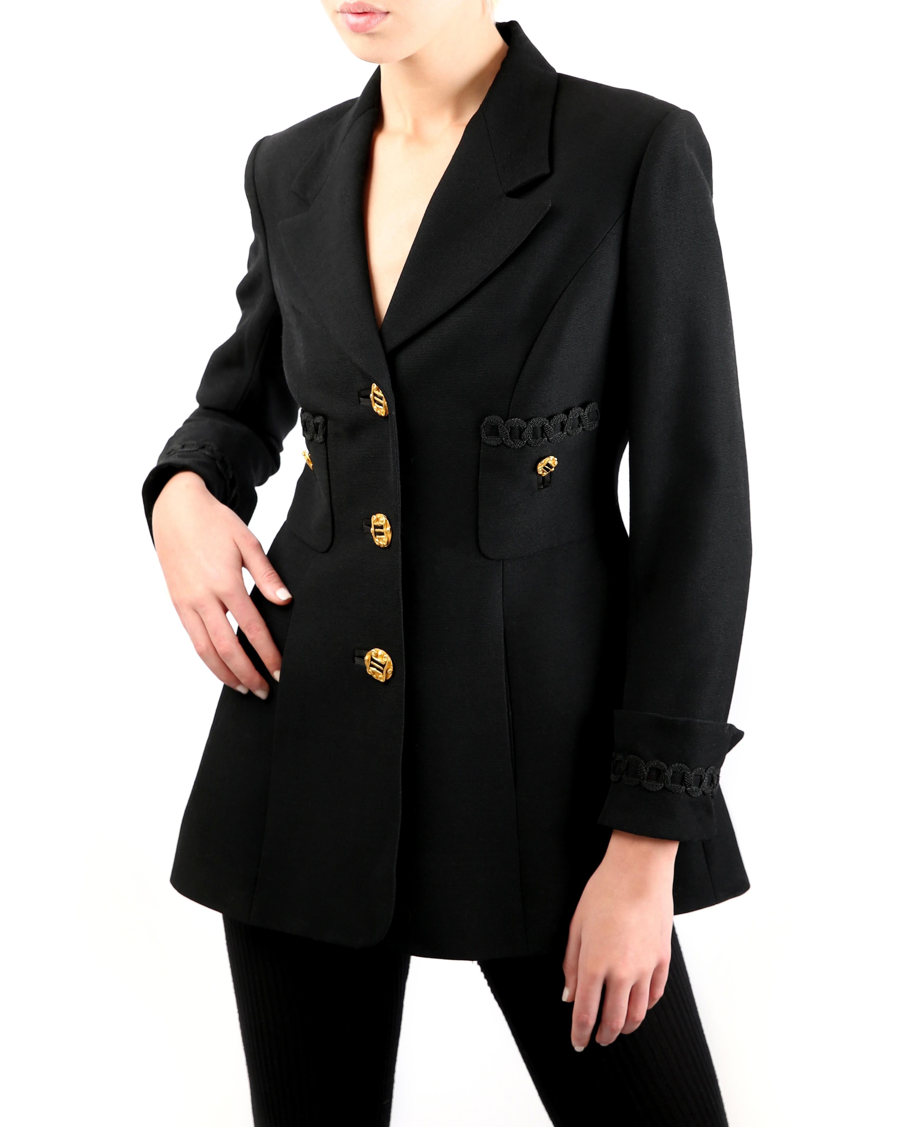 Louis Feraud vintage black blazer in wool
Three oversized gold buttons running down the centre front in order to close the jacket 
Two decorative buttons to two upper pockets on the right and left bust
One gold button to each sleeve cuff
Two