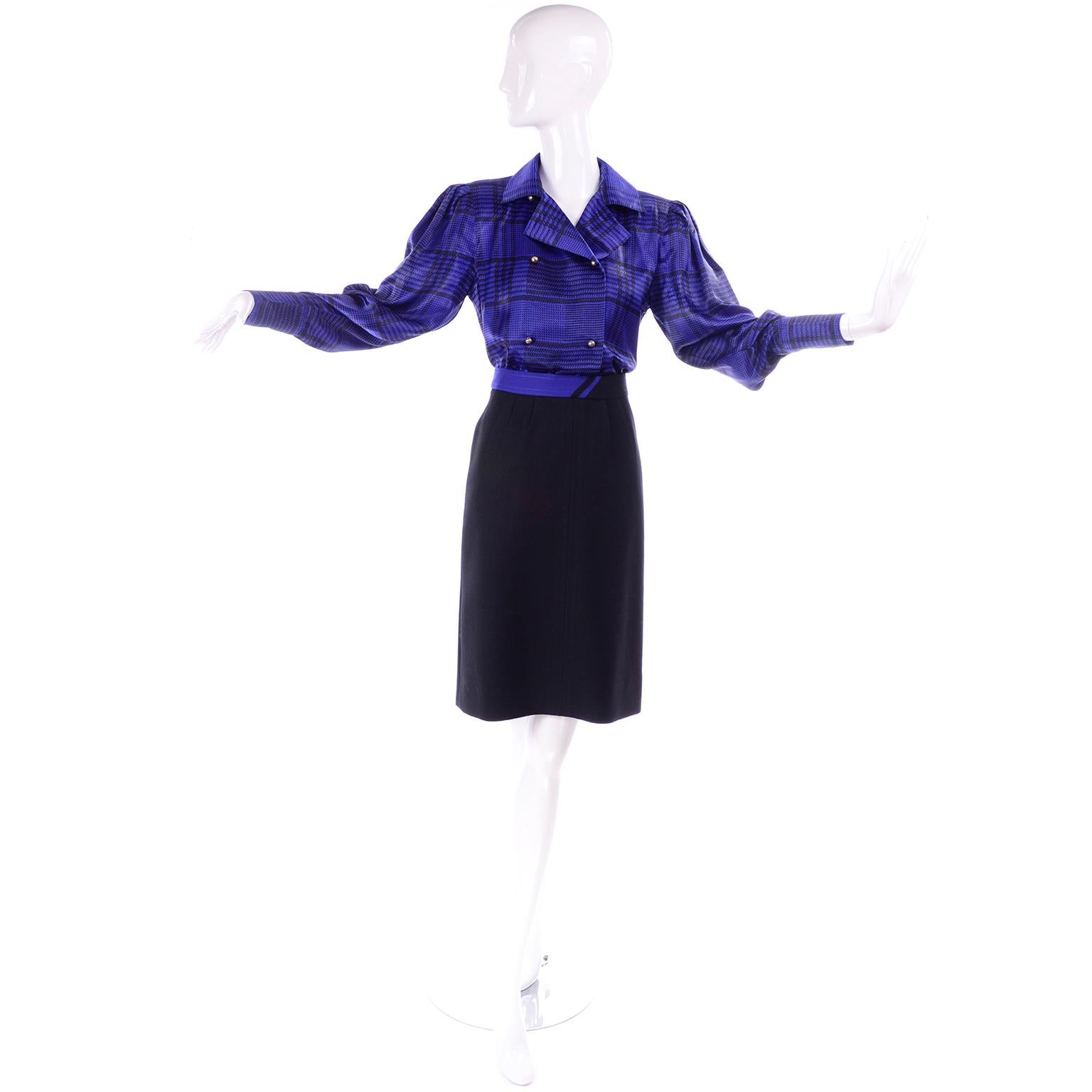 This is a 3 piece ensemble that includes a blue and black plaid silky blouse with an adjustable neck tie and a black wool skirt with blue details on the waistband that match the skirt. The skirt is fully lined and has small pleats from the
