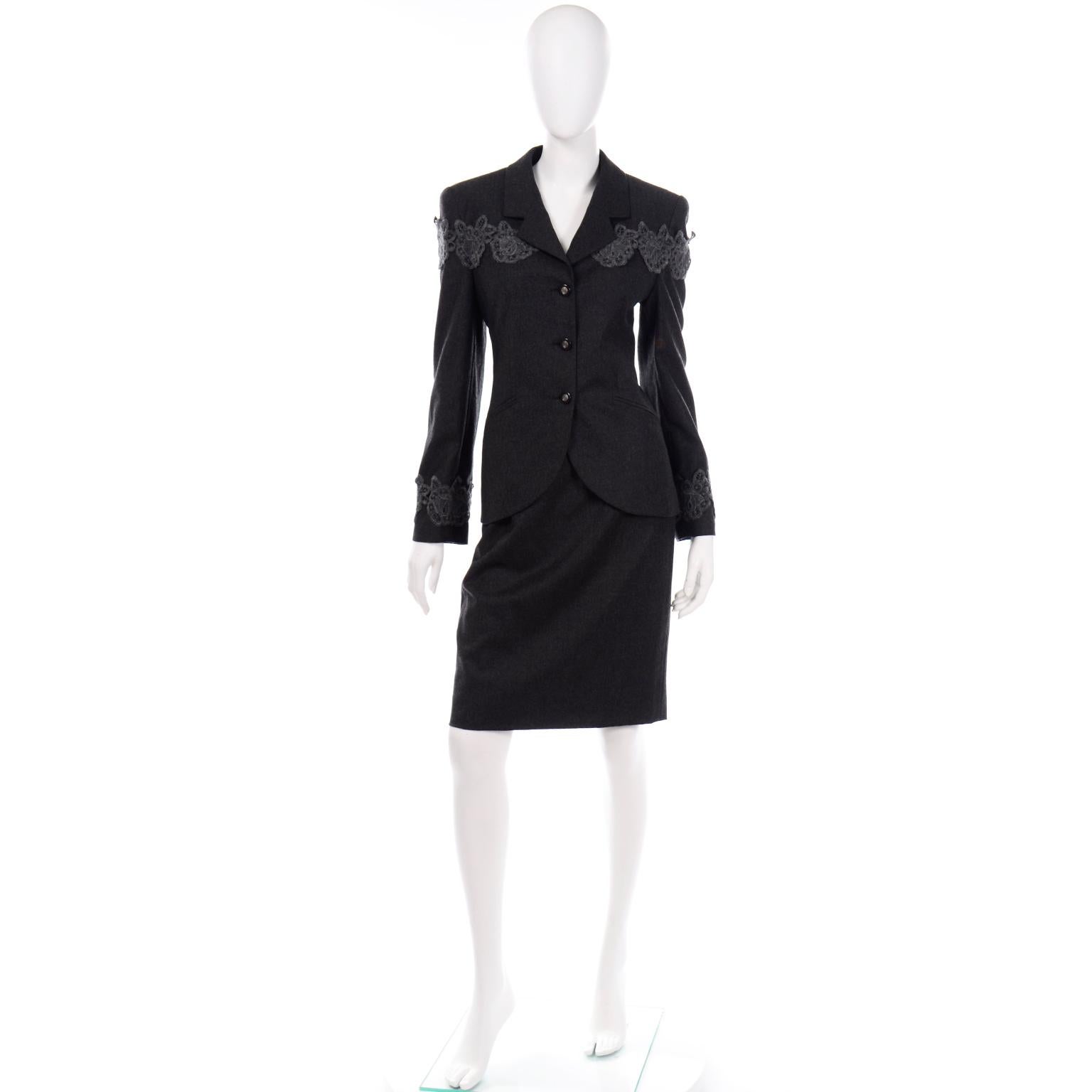 This is a beautiful vintage charcoal grey Louis Feraud skirt suit in 100% Virgin Wool. The blazer has a notched lapel with monogram black and silver buttons up the front and front slit pockets. The slim skirt hits just above or at the knee,