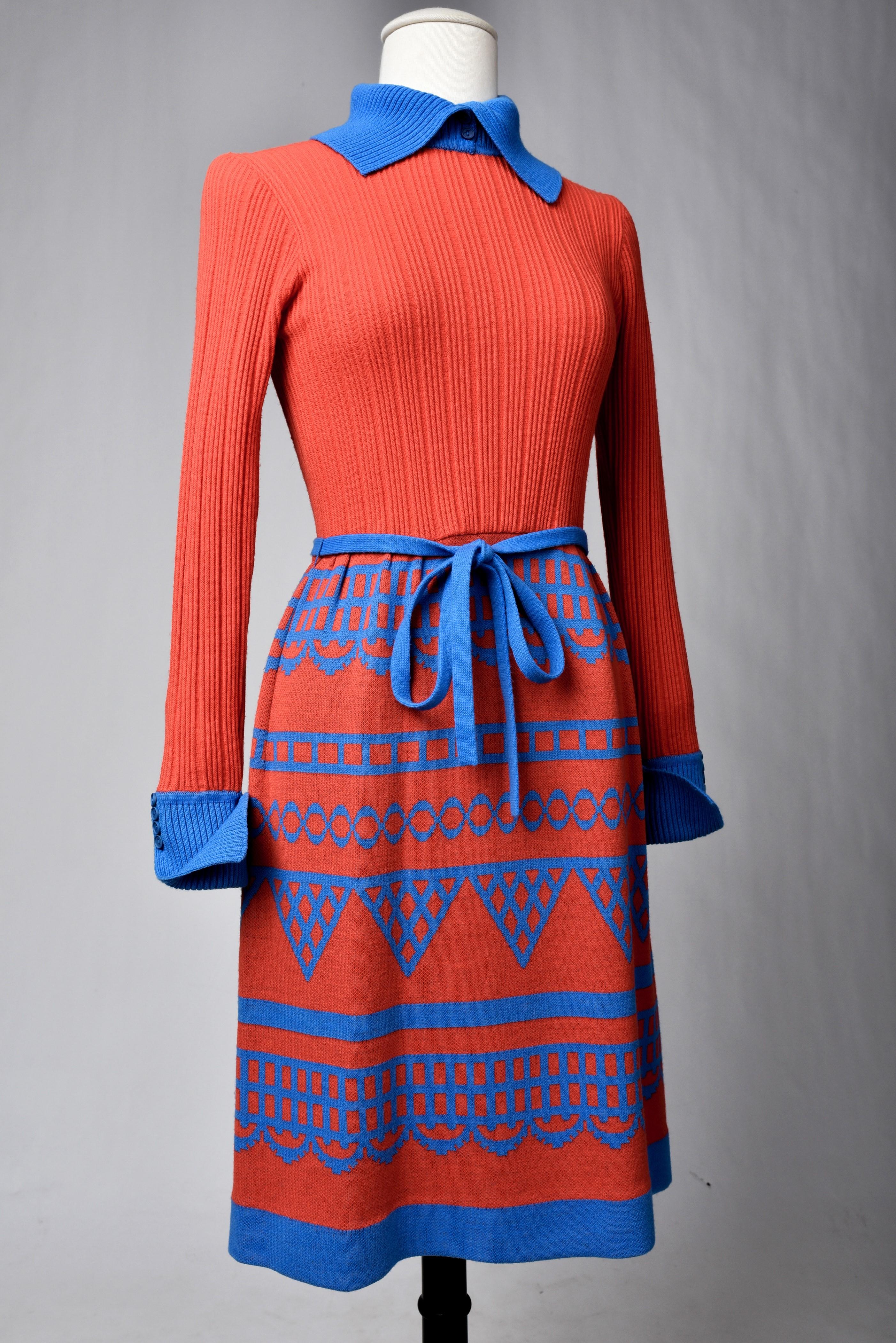 Circa 1975 - 1980
France - England

Scarlet red and blue wool knit day dress signed Miss Féraud by Rembrandt, British branch of the famous French House.  Straight day dress, long sleeves and turtleneck with buttoned flap cuffs. Zip closure in the