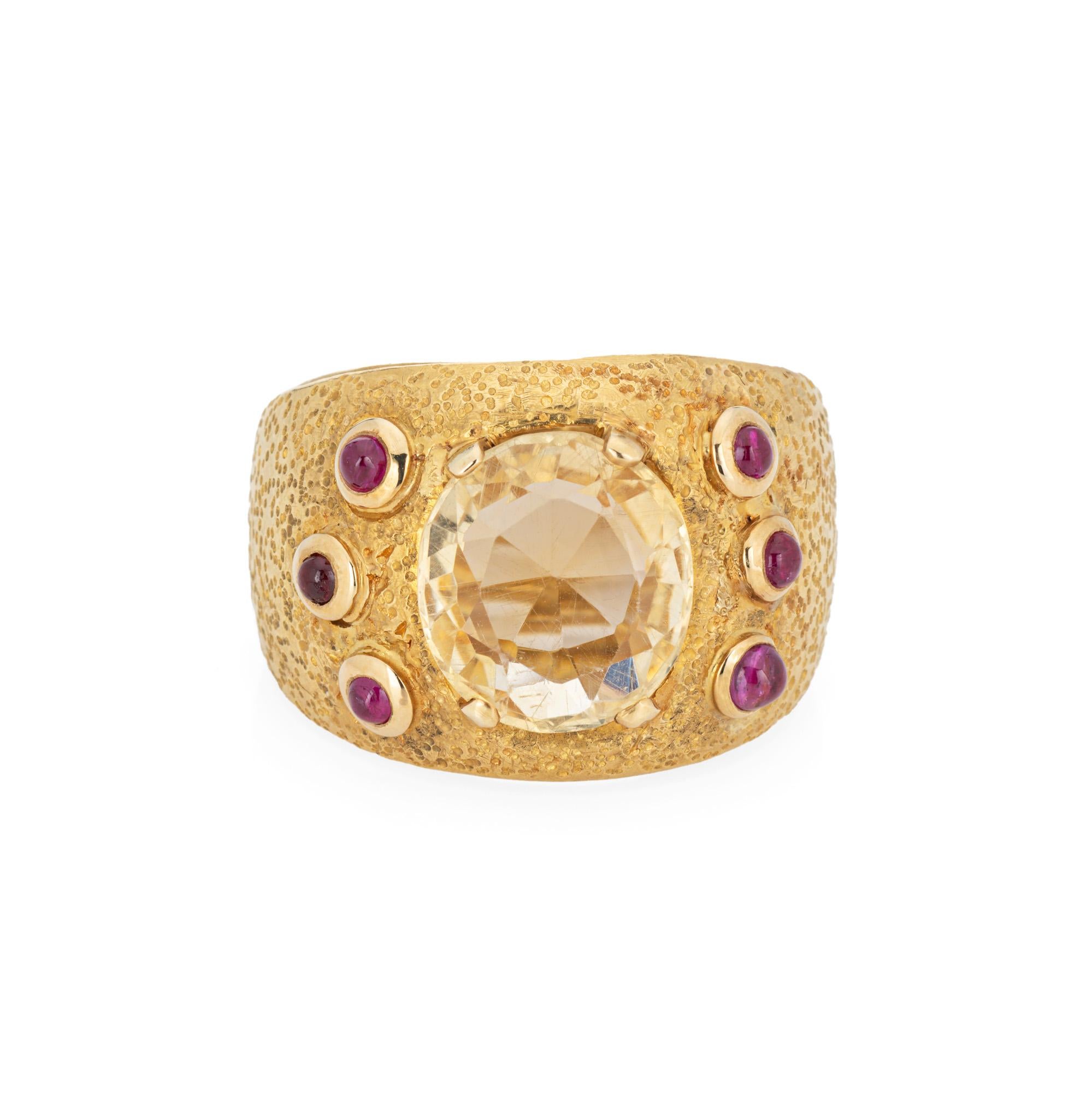 Finely detailed vintage Louis Feron citrine & ruby ring crafted in 18 karat yellow gold (circa 1960s). 

Centrally round citrine measures 12.5mm (estimated at 5 carats). Six cabochon cut rubies measure 2mm each. The gemstones are in very good