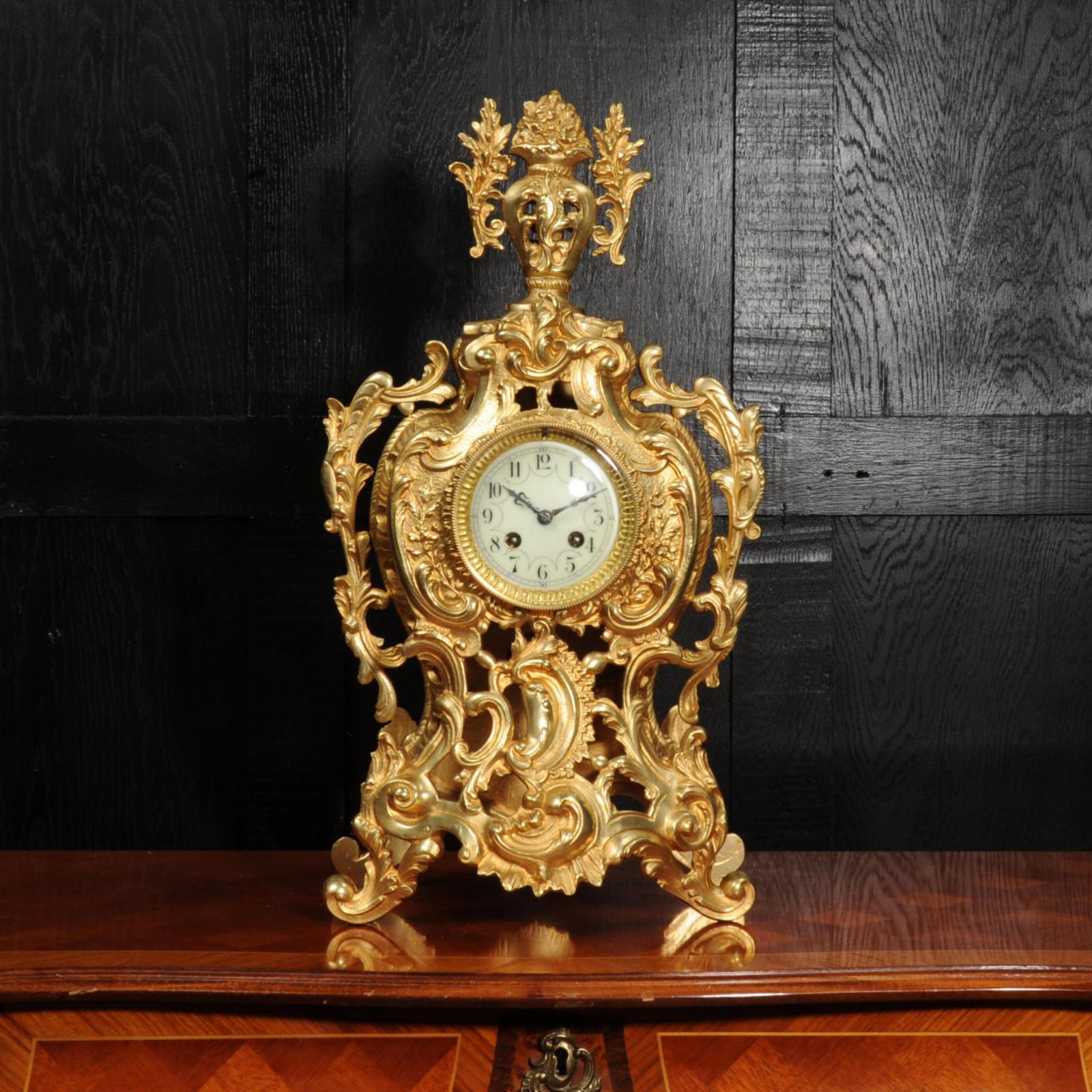~ French - Circa 1880 ~

~~ Excellent condition, fully overhauled ~~

A large and superb antique French gilt bronze Rococo clock. It is flamboyantly modelled with bold scrolls of acanthus applied to the waisted case with a large urn of flowers