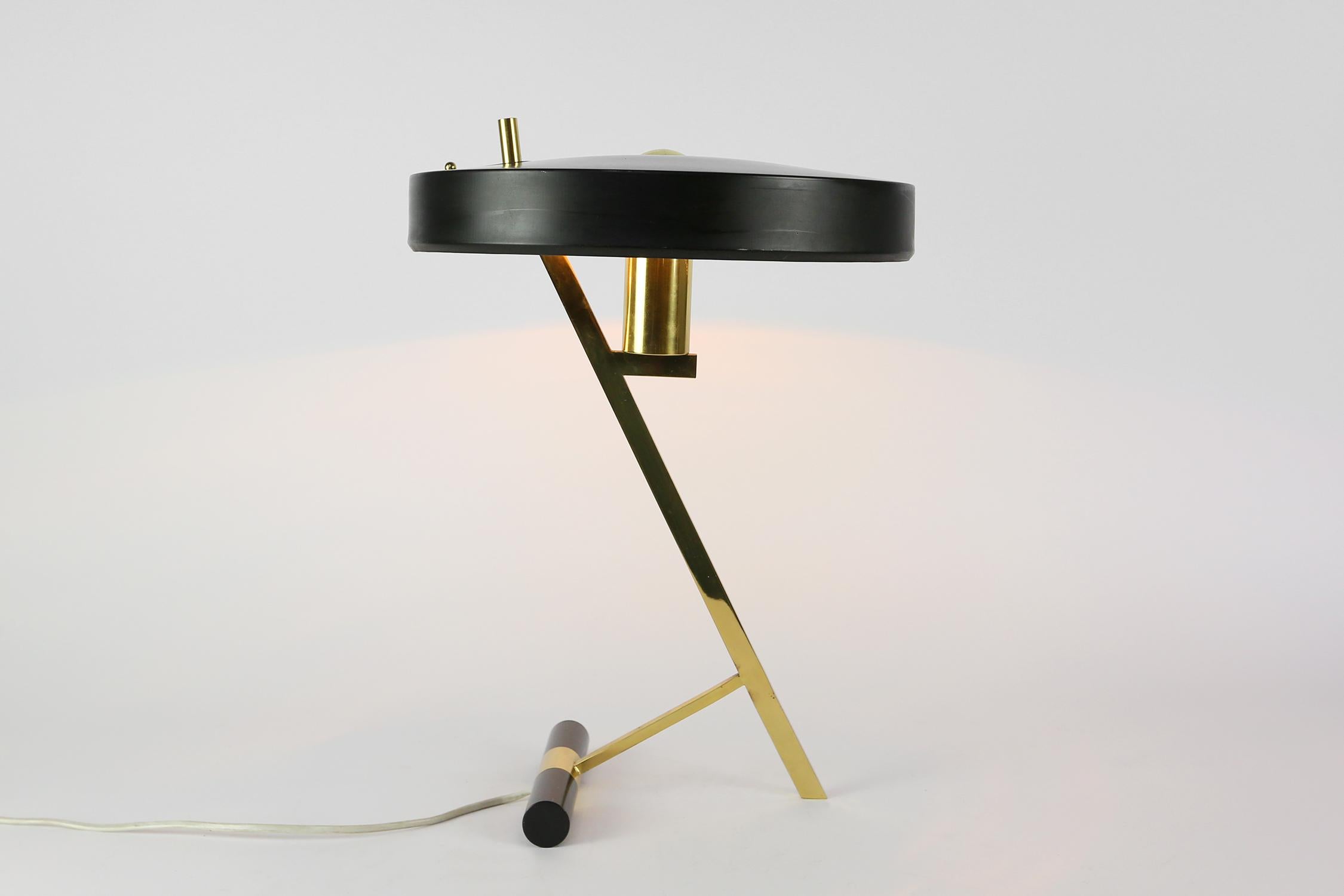 Rare Z-shaped desk lamp designed by former head-designer at Philips Netherlands Louis Kalff. Beautifully designed brass Z-frame and still has the original brass manufacturer tag on the shade. 
Design from 1955. With the original brass Philips