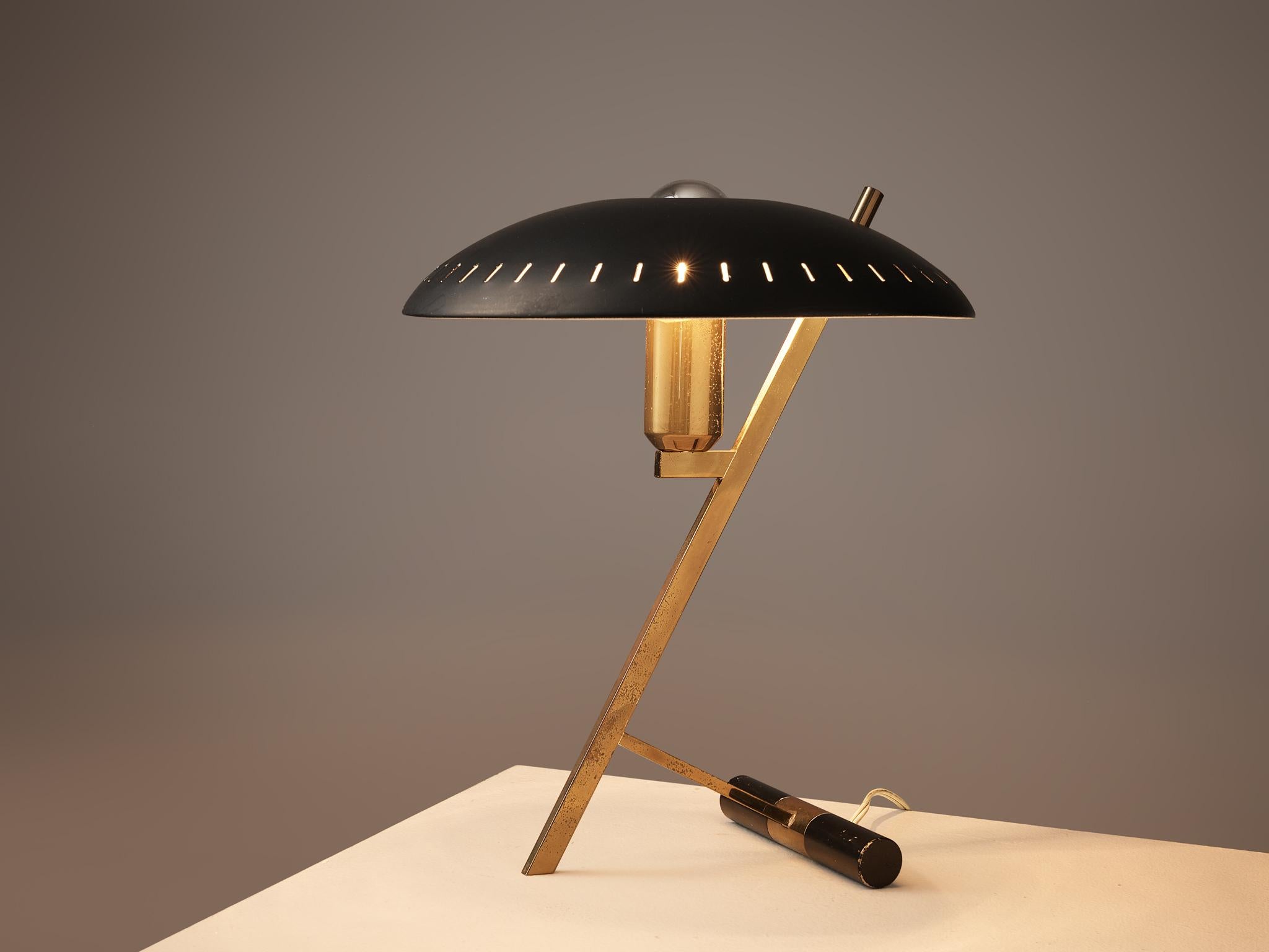 Louis Kalff for Philips, 'Z' table lamp, metal, brass, the Netherlands, 1950s

Louis Kalff placed a black metal shade with small gaps and a circular gap on top where the lightbulb reaches out on a brass stem. The golden stem has a diagonal part