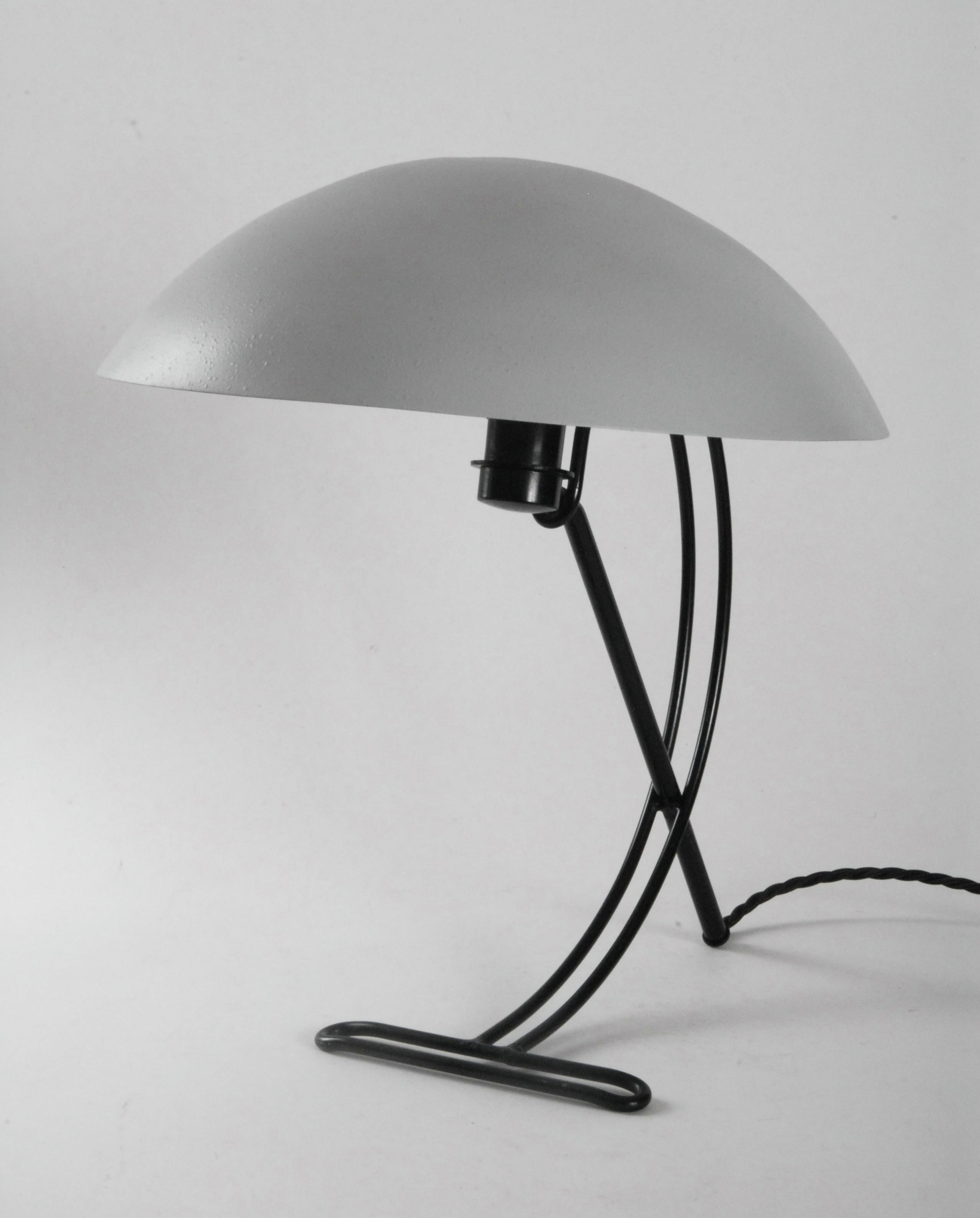 A Louis Kalff designed desk lamp from the late 1950s model NB100 with black steel frame and grey painted finish shade, re-wired with an Australian plug. It is in excellent condition.