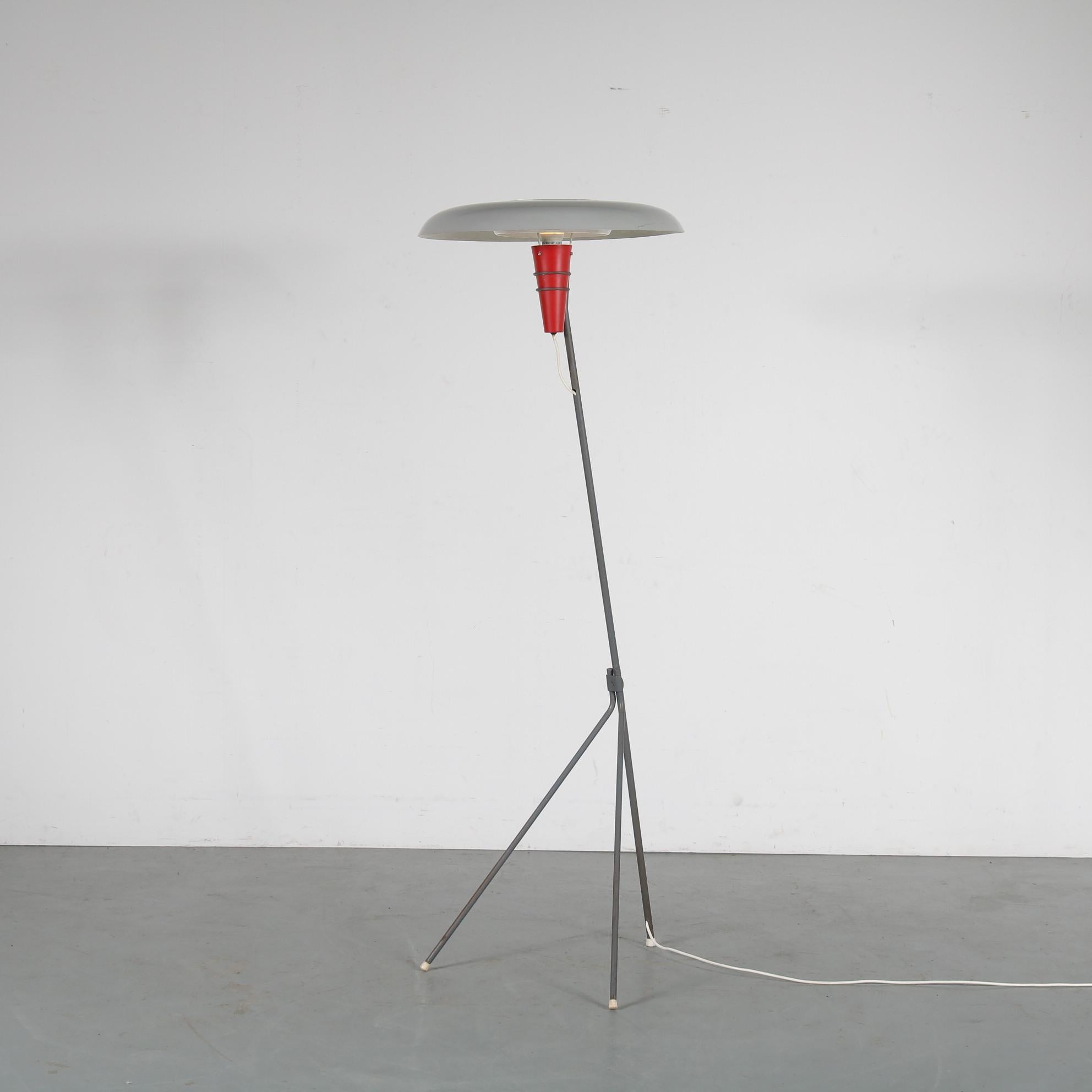 This is a very rare floor lamp, model NX38, designed by Louis Kalff and manufactured by Philips in the Netherlands around 1950.

This stunning piece is a very rare find of Dutch design! It has a thin grey metal arm with tripod base, holding a red