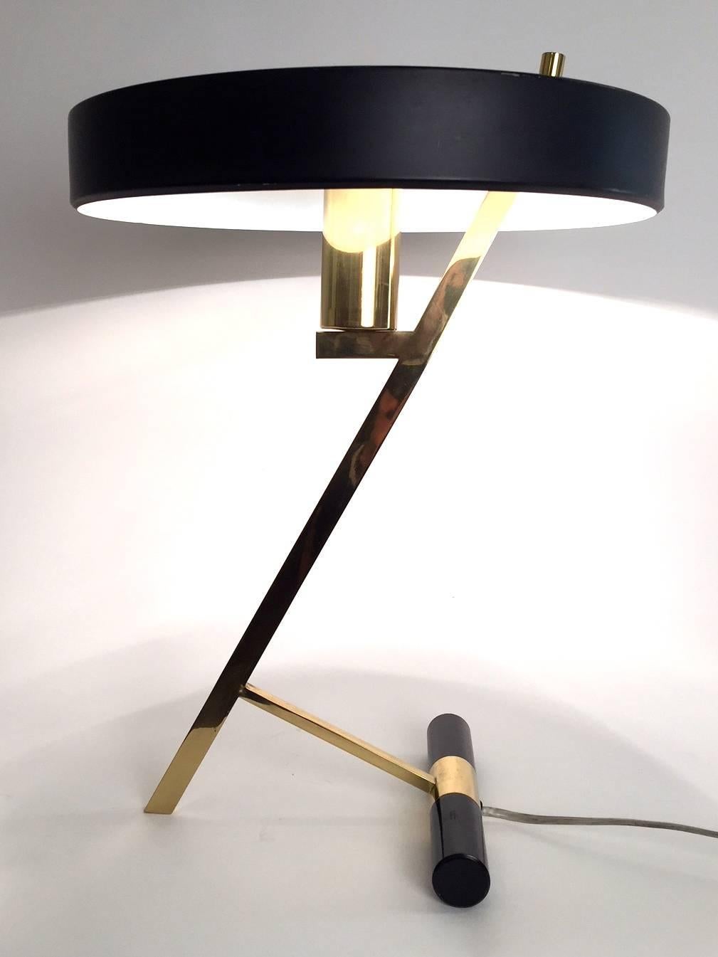 A Z-shaped table lamp designed by Louis Kalff and edited by Phillips in 1953 .Enameled black metal, round shaped shade and brass base. Excellent condition.