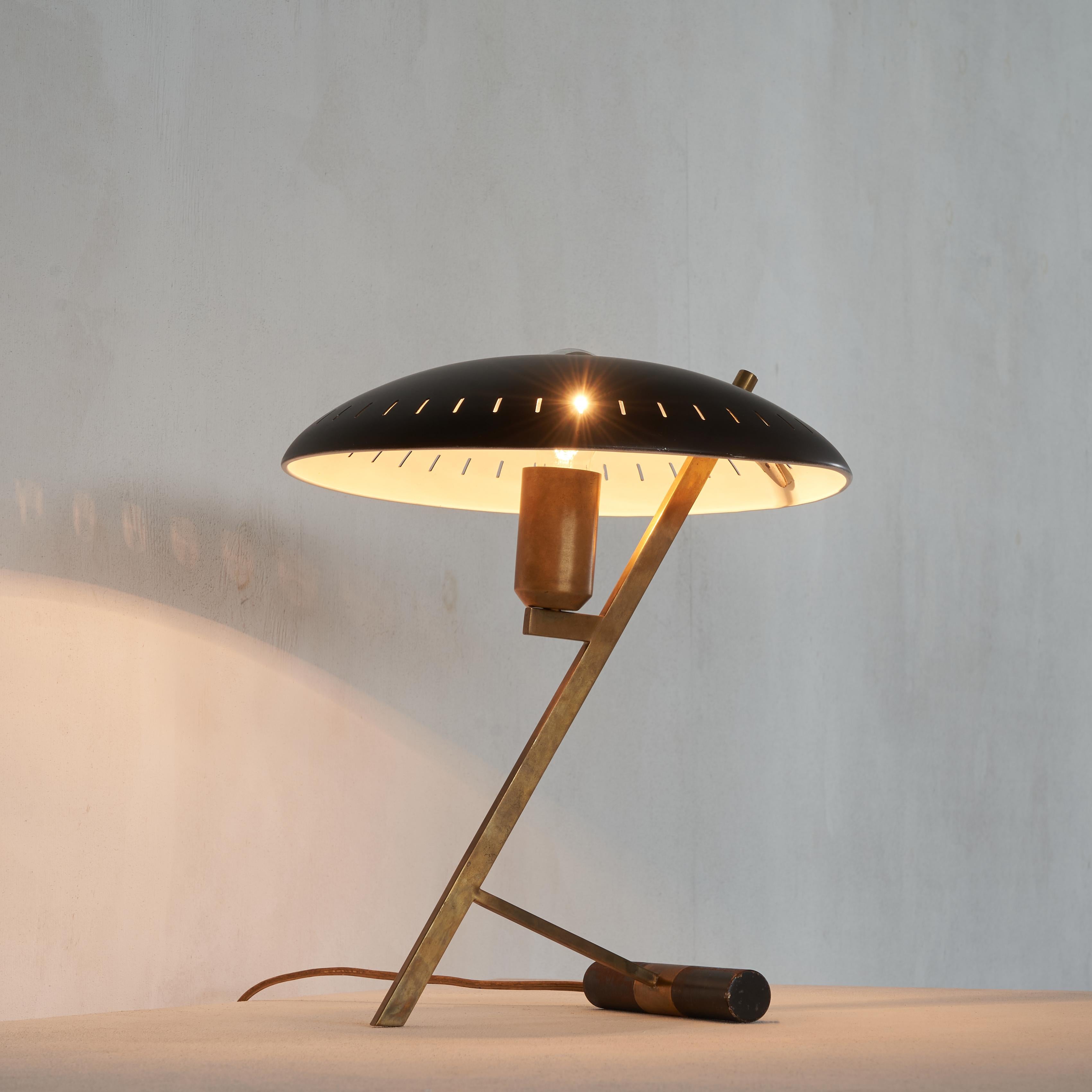 Beautifully patinated iconic Z lamp by Louis Kalff for Philips. This model is officially called the L 588 FD, but is known as the Z lamp because of it’s Z shaped frame. Our Z shows a really great patina on both the brass frame and the shade. In our