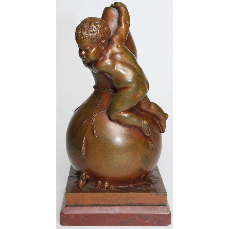 Louis Kley (French, 1833-1911) A fine and charming patinated bronze group of a young boy climbing on a vase fearful of two mice. The finely executed bronze group depicting an naked infant boy atop of a bottle-shaped vase scared of two mischievous