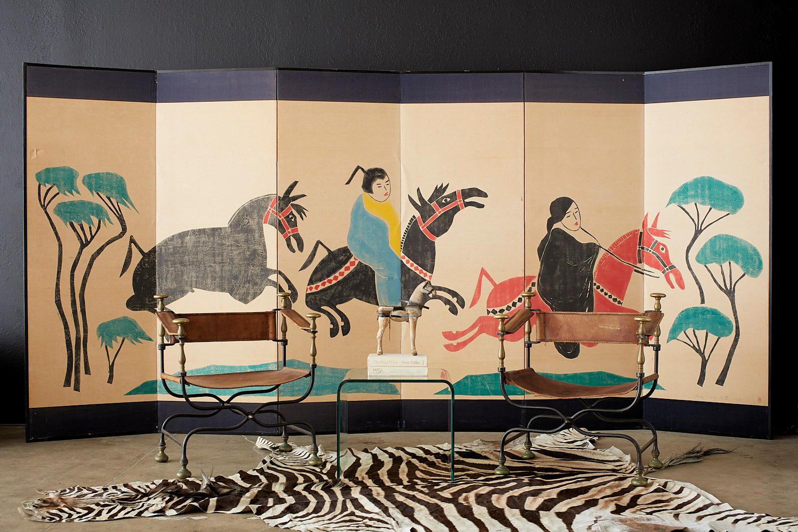 Monumental Chinese woodblock print by Louis Liang. Modern style six-panel depicting figures on horseback with ink and vibrant color pigments on handcrafted paper. Set in a large ebonized wood frame with a silk brocade border on top and bottom.