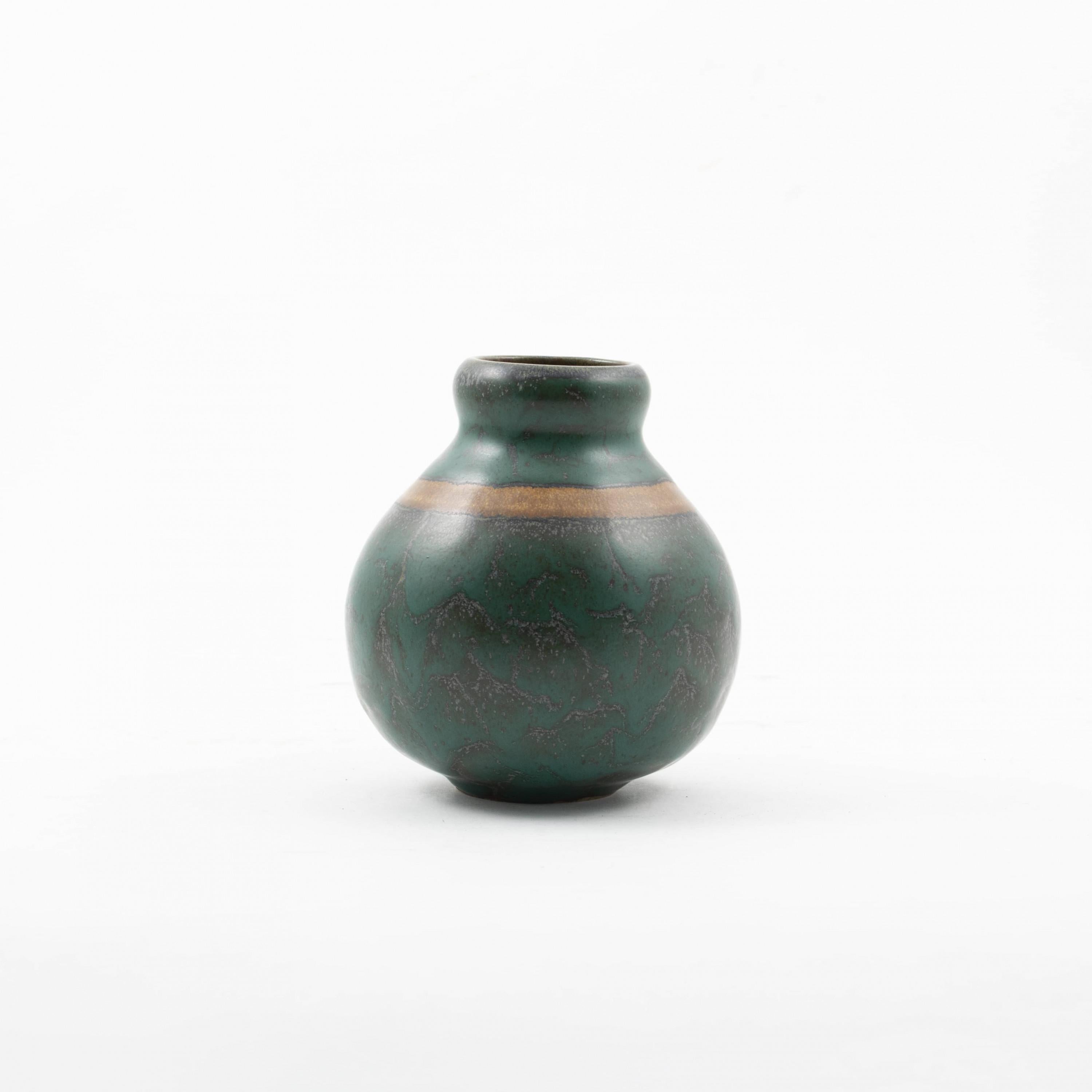 Louis Lourioux 1874-1930.
Beautiful and decorative stoneware vase decorated in turquoise-green glaze with a caramel-colored band.

Signature with the wolf stamp.
France approx. 1920.