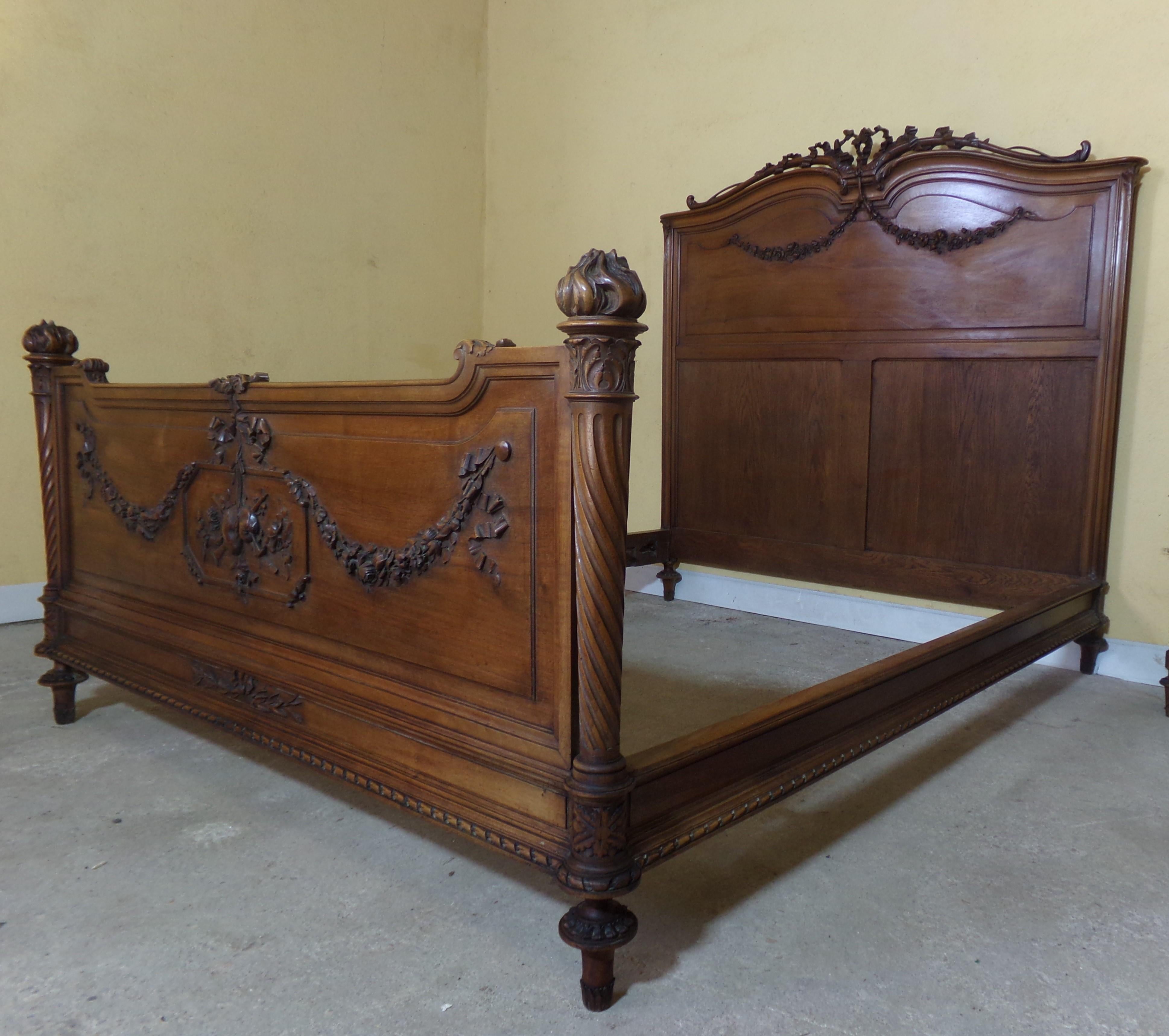 Grand Hand carved solid walnut queen size bed in the Louis XVI style C1890. Undoubtedly a unique custom made marriage bed of the period carved and made by a master craftsman 