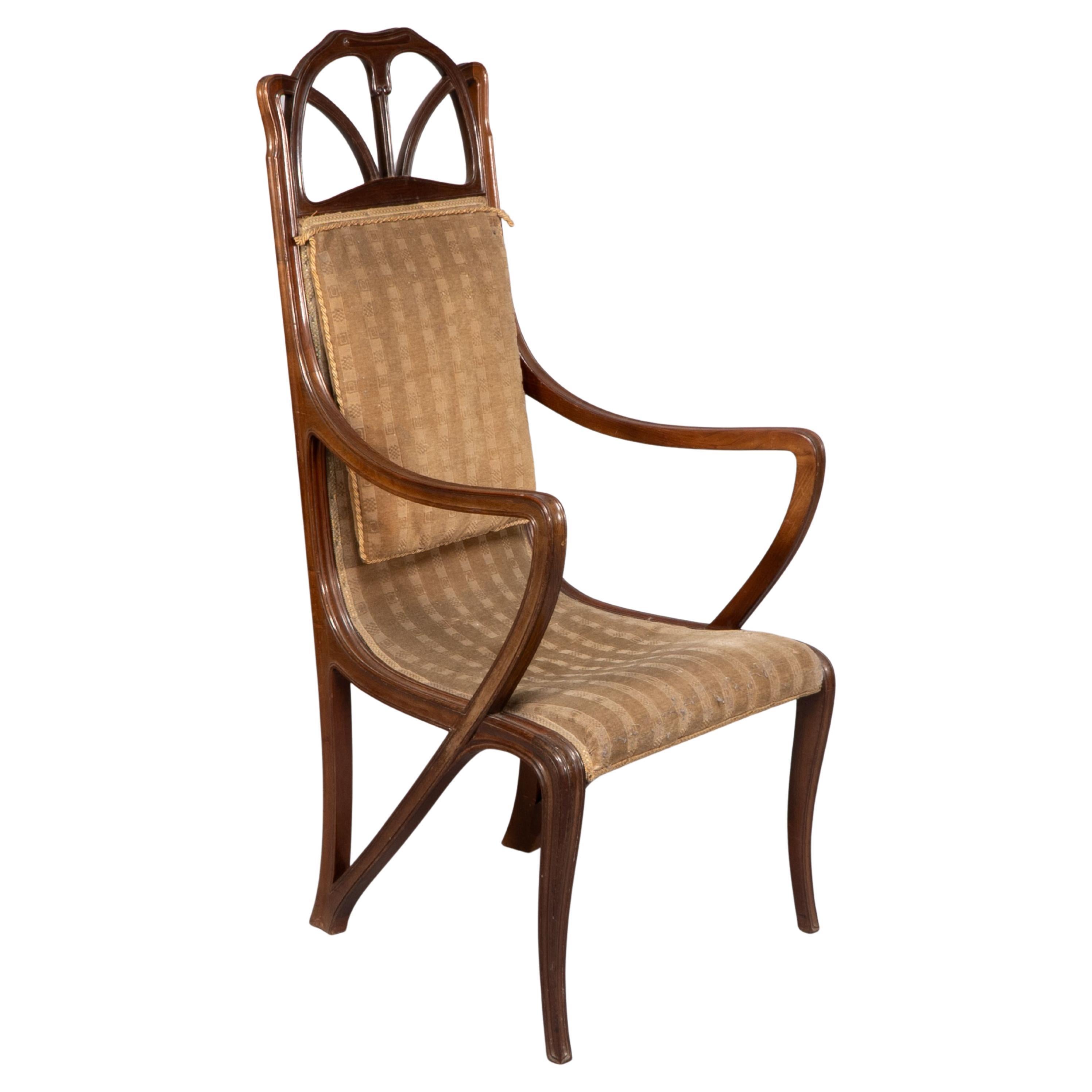 Louis Majorelle. Art Nouveau carved walnut armchair with original period fabric