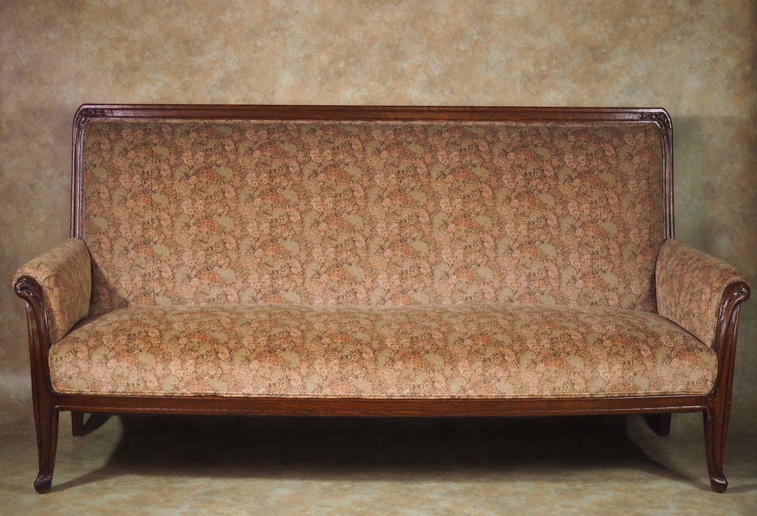 French Art Nouveau sofa in oak by Louis Majorelle, circa 1905. It is unusual to find a full-length Art Nouveau sofa and this good example by Louis Majorelle is correctly restored, refinished and reupholstered. The fabric is a re-issue by original
