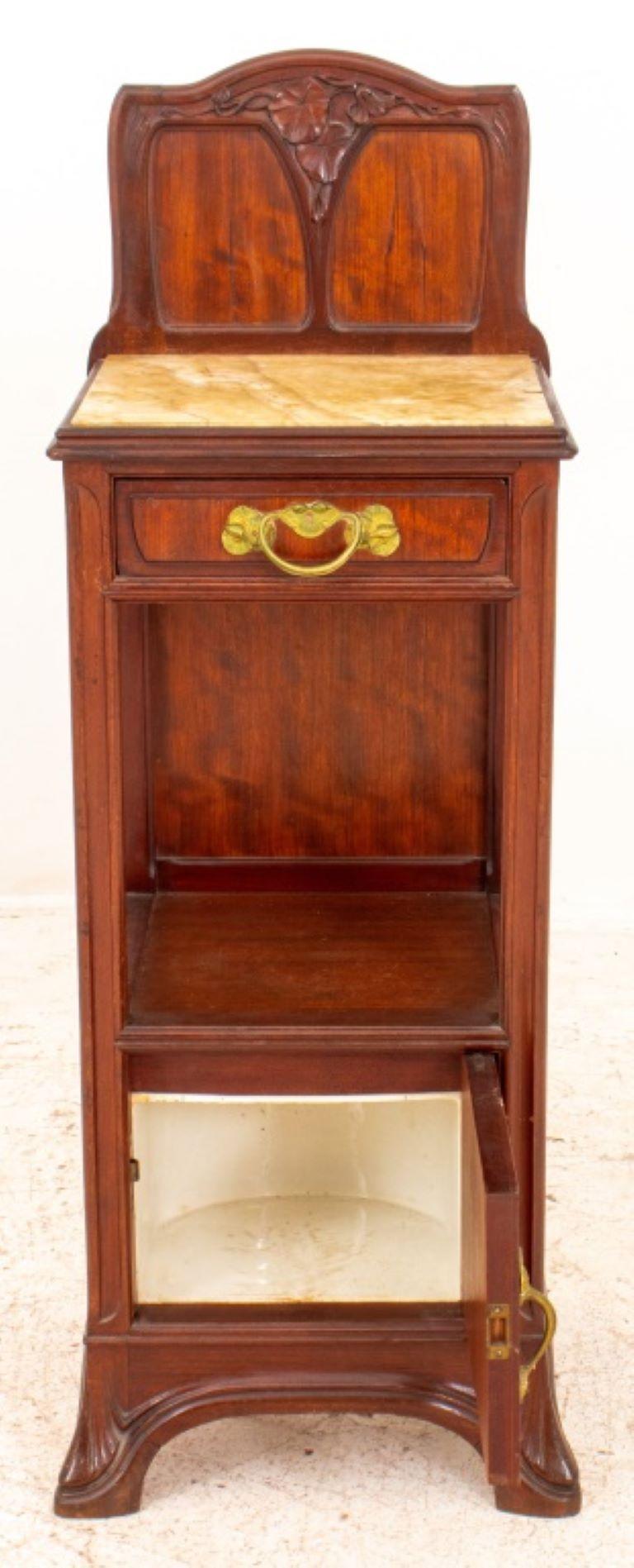 Louis Majorelle (French, 1859-1926) attributed Art Nouveau mahogany wood and stone wash stand, with undulating organic Art Nouveau ornamentation, the back splash with carved morning glory flowers over an inset onyx slab above a short drawer and a