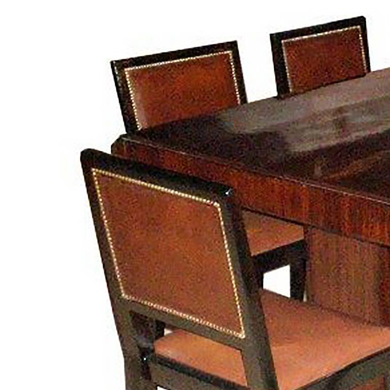 French Art Deco table in zebrawood; 6 chairs with original brown leather upholstery. Table signed Majorelle Nancy.