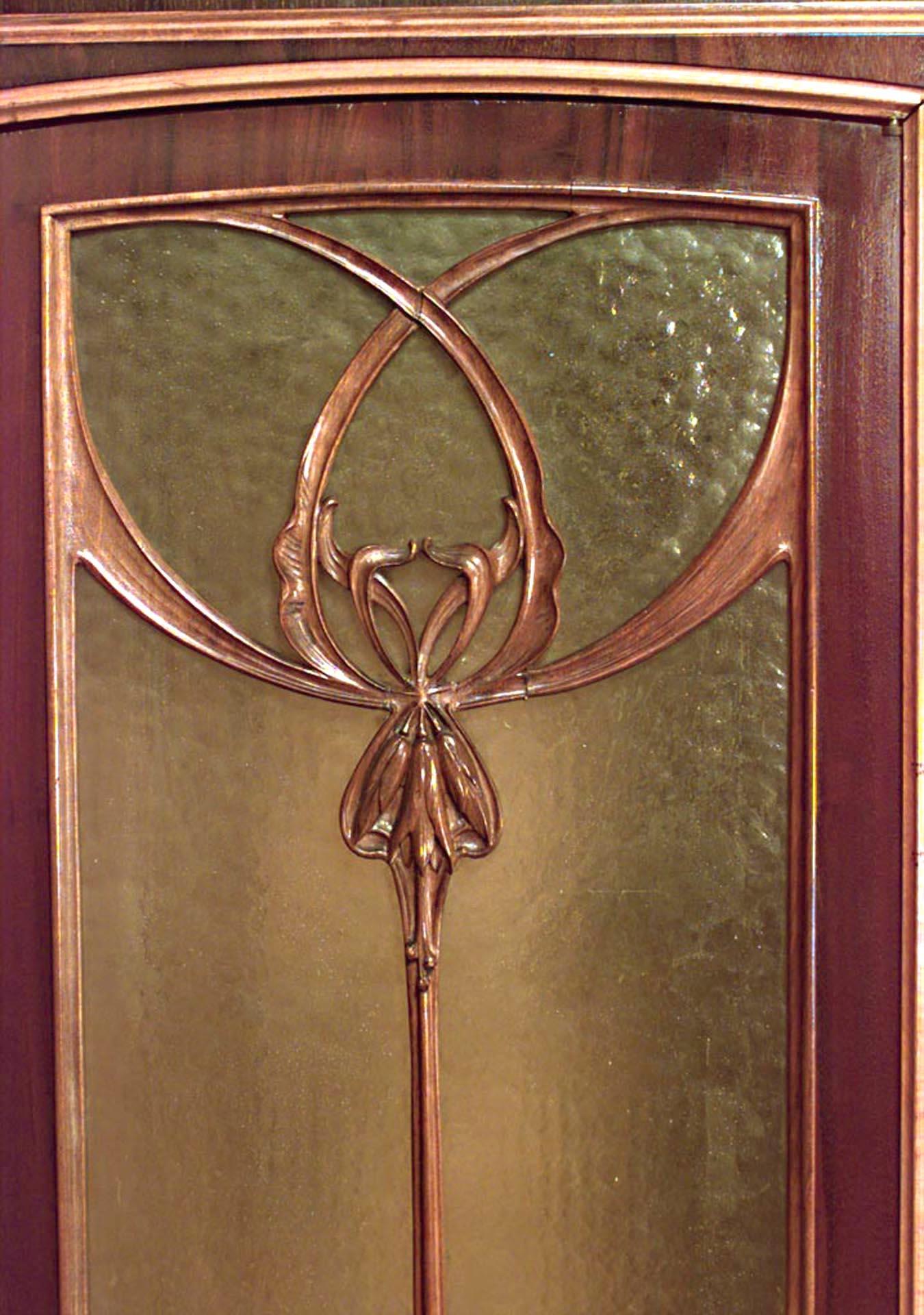 French Art Nouveau walnut and inlaid floral design 3 door armoire cabinet with shelf on bottom and top with spindle sides. (signed: LOUIS MAJORELLE).
      