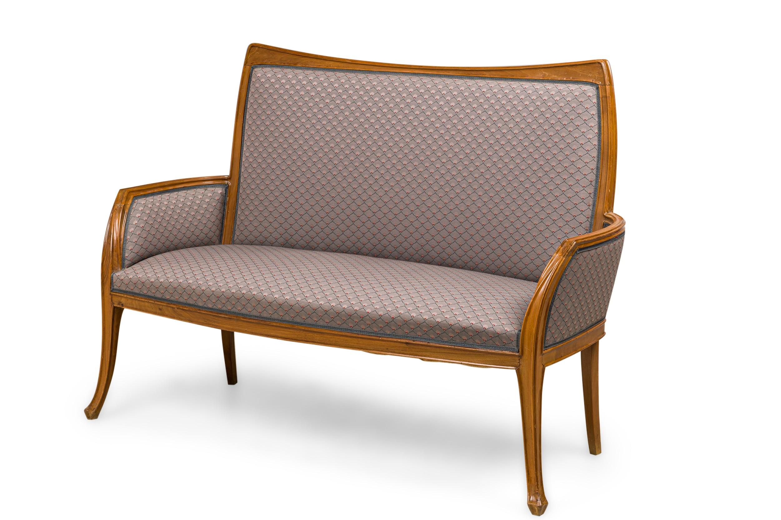 French Art Nouveau walnut frame settee with slightly flaired arms and shaped back upholstered in a lightly patterned gray-blue fabric with matching upholstered pillow. (LOUIS MAJORELLE)
 

 Wear to frame finish