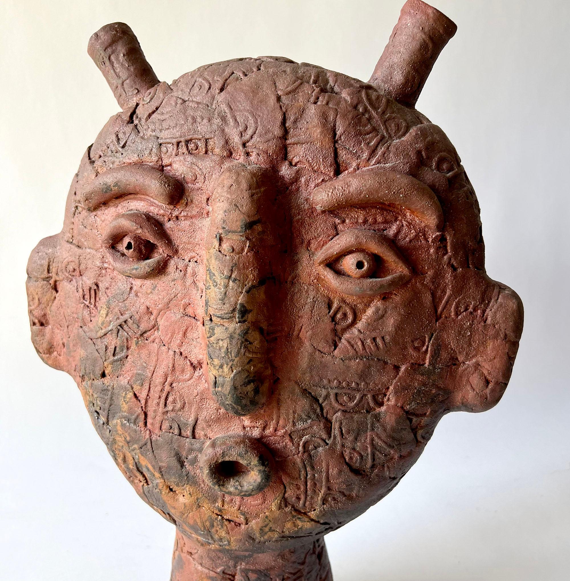 Louis Mendez (American, 1929-2012) handmade ceramic pottery head sculpture with applied symbols. Piece measures 16