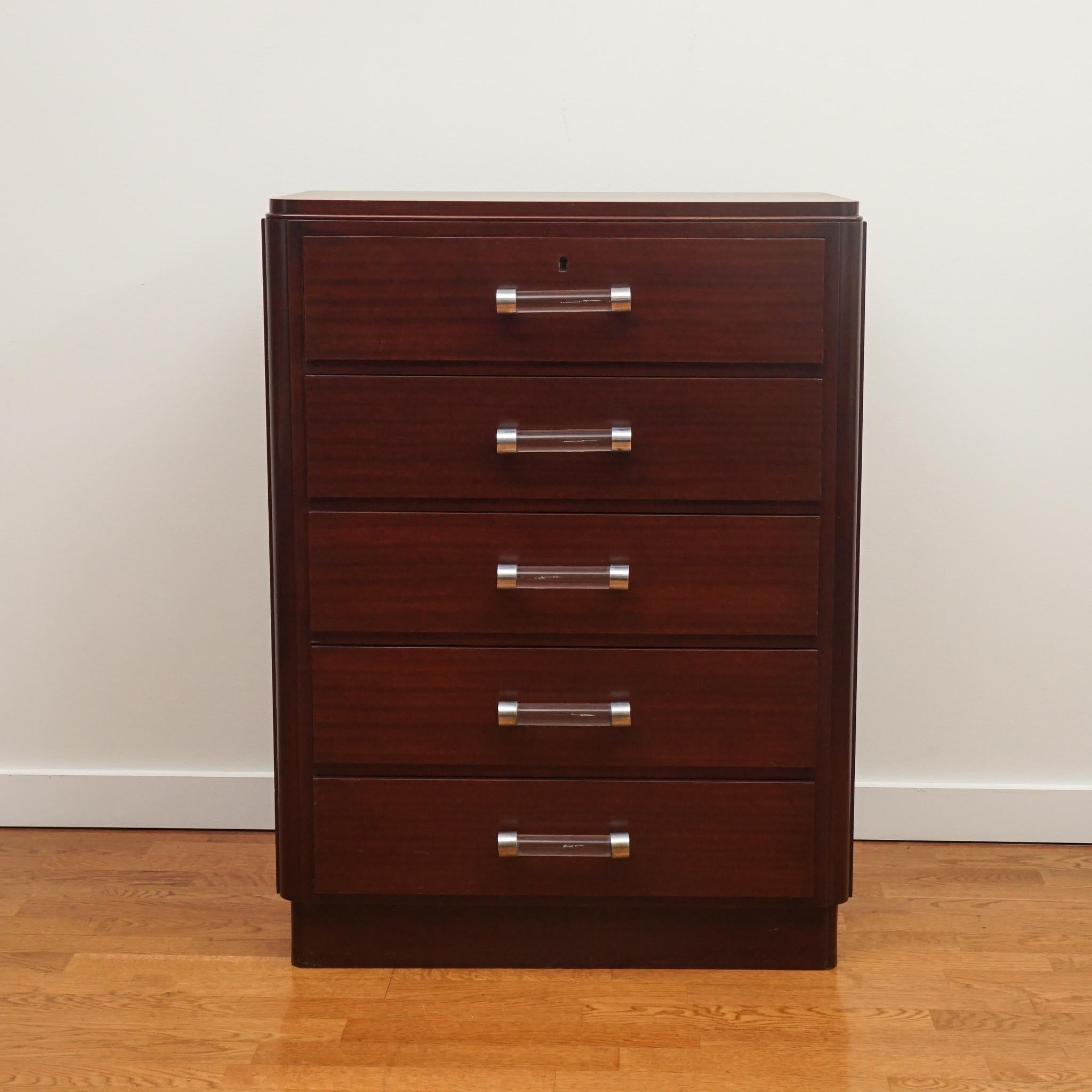This mahogany office cabinet was designed by French deco master Louis Neiss and made in 1935. In addition to its beautiful restored mahogany finish, the cabinet features the original glass and metal drawer pulls. Very good condition given its age.