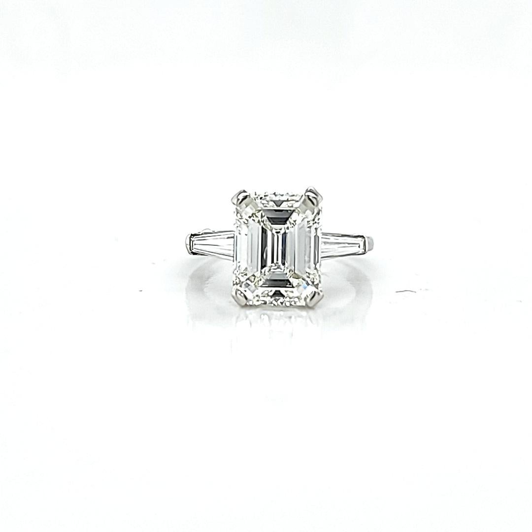 Center stone is a 4.01 color J color Si2 clarity GIA certified. If you want a nice sized Emerald Cut on a budget this is a great stone. J color is on the whiter side. The SI2 (which we usually advise against in Emerald Cuts) is all white inclusions