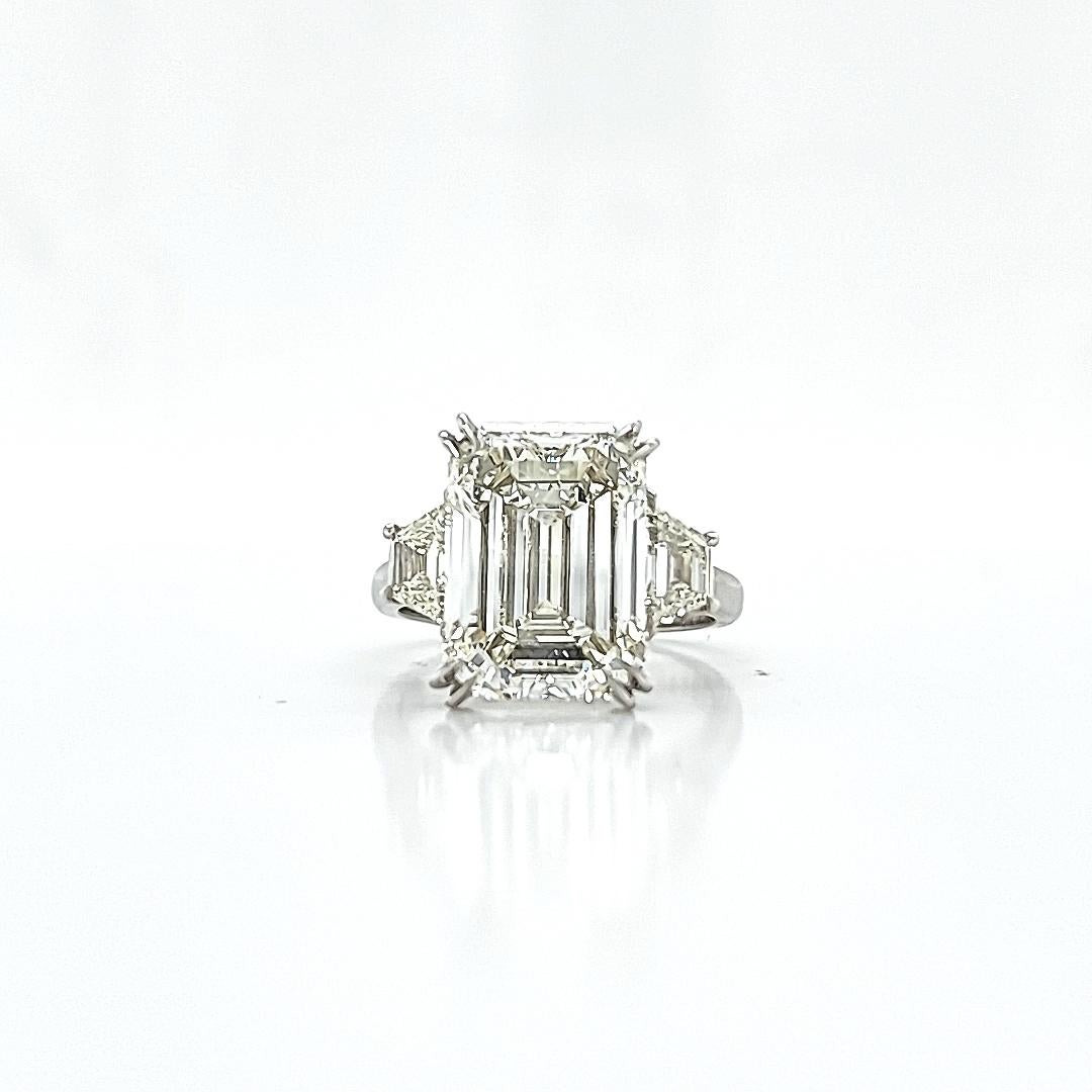 Center Stone is a GIA certified 7.02 carat Diamond, L color, VS2 Clarity. 1.37 Ratio and 65% depth gives this 7.02 carat the proper look, not like a squatty diamond. Set in a hand made platinum ring with 2 trapezoid shaped diamonds of matching